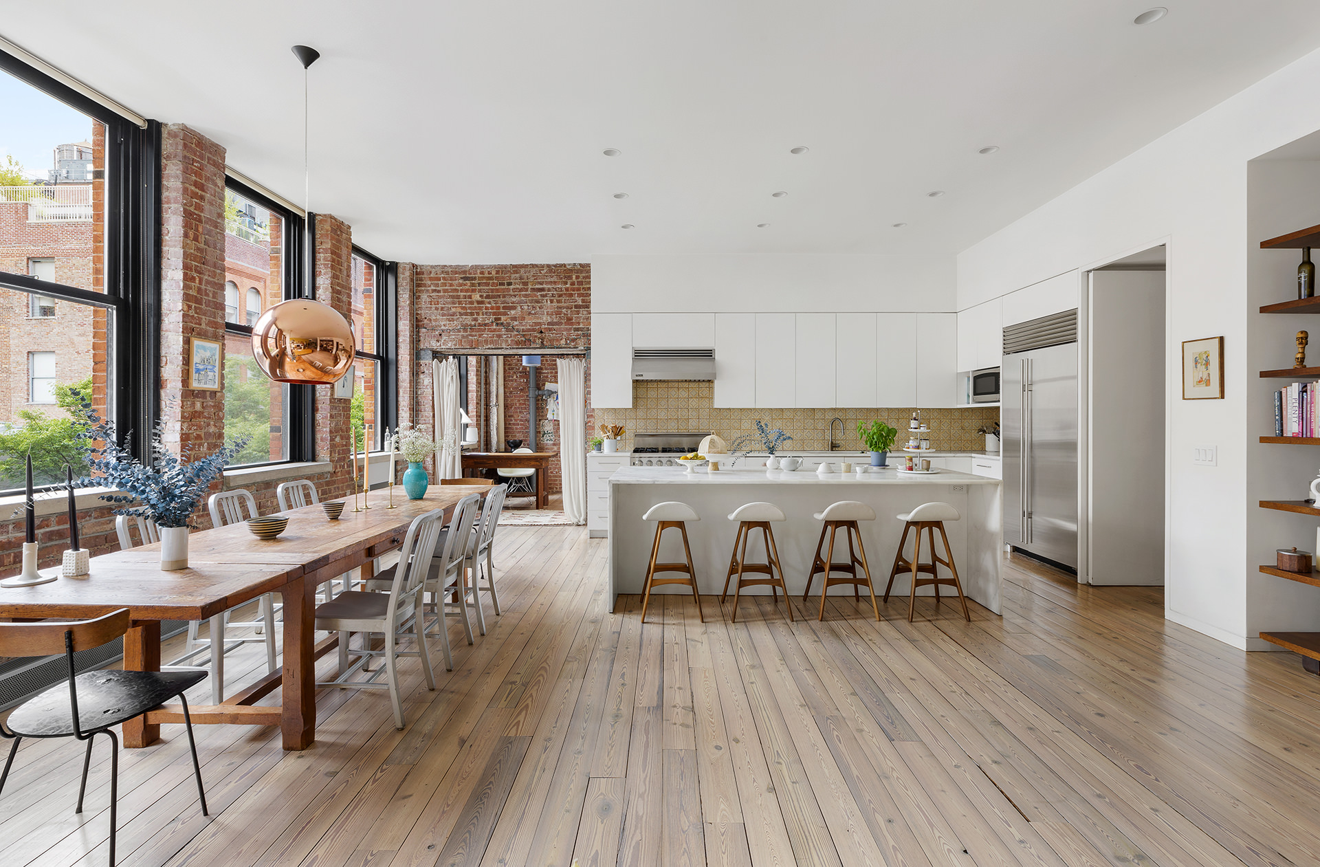 525 West 22nd Street, Unit 3AF Manhattan, NY 10011 - Photo 2 of 25 a room with stainless steel appliances a dining table chairs and wooden floor