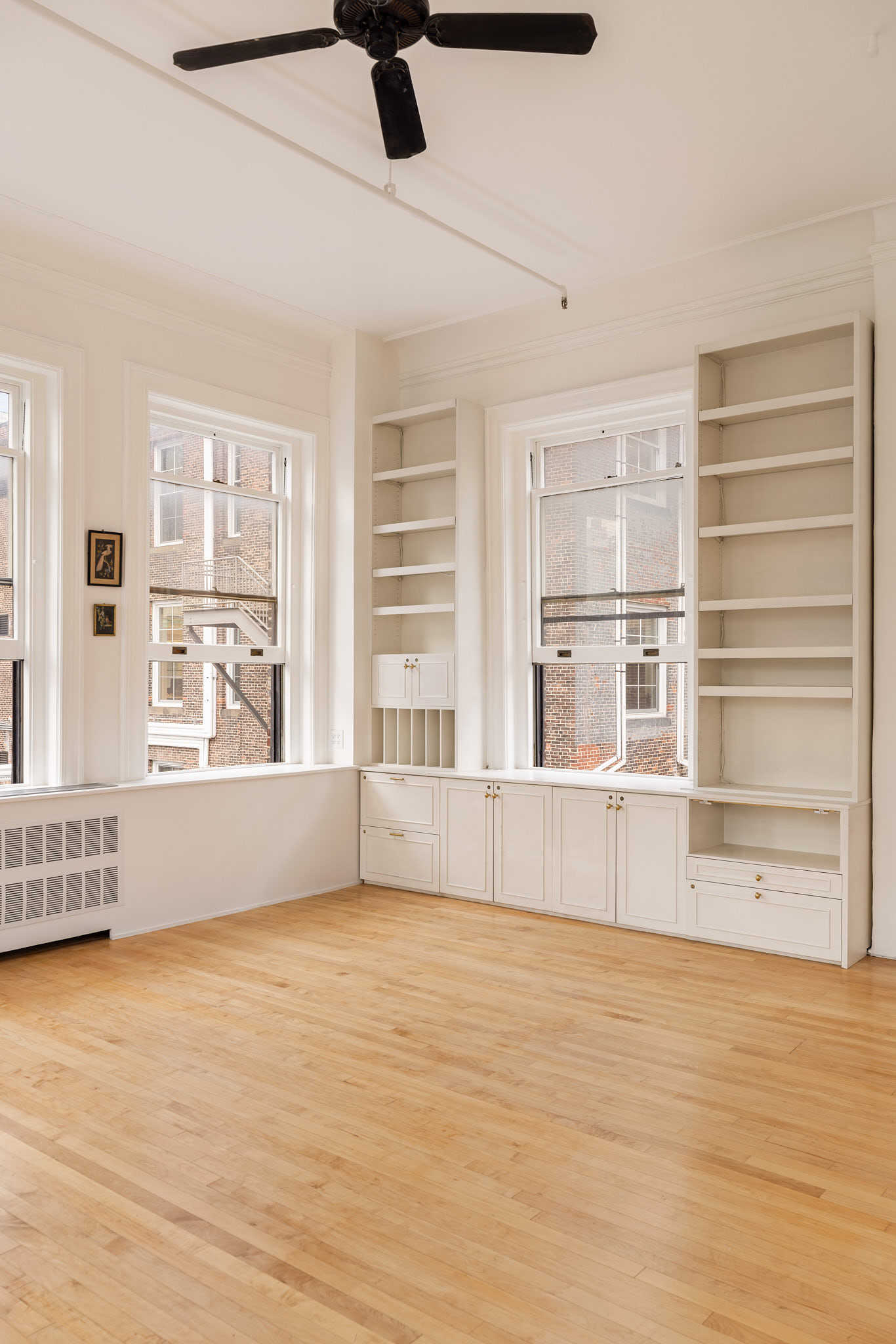 874 Broadway, Unit 907 Manhattan, NY 10003 - Photo 13 of 22 a view of an empty room with a window and wooden floor