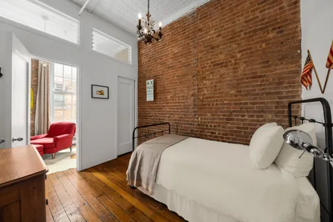 a bedroom with a bed and a chandelier