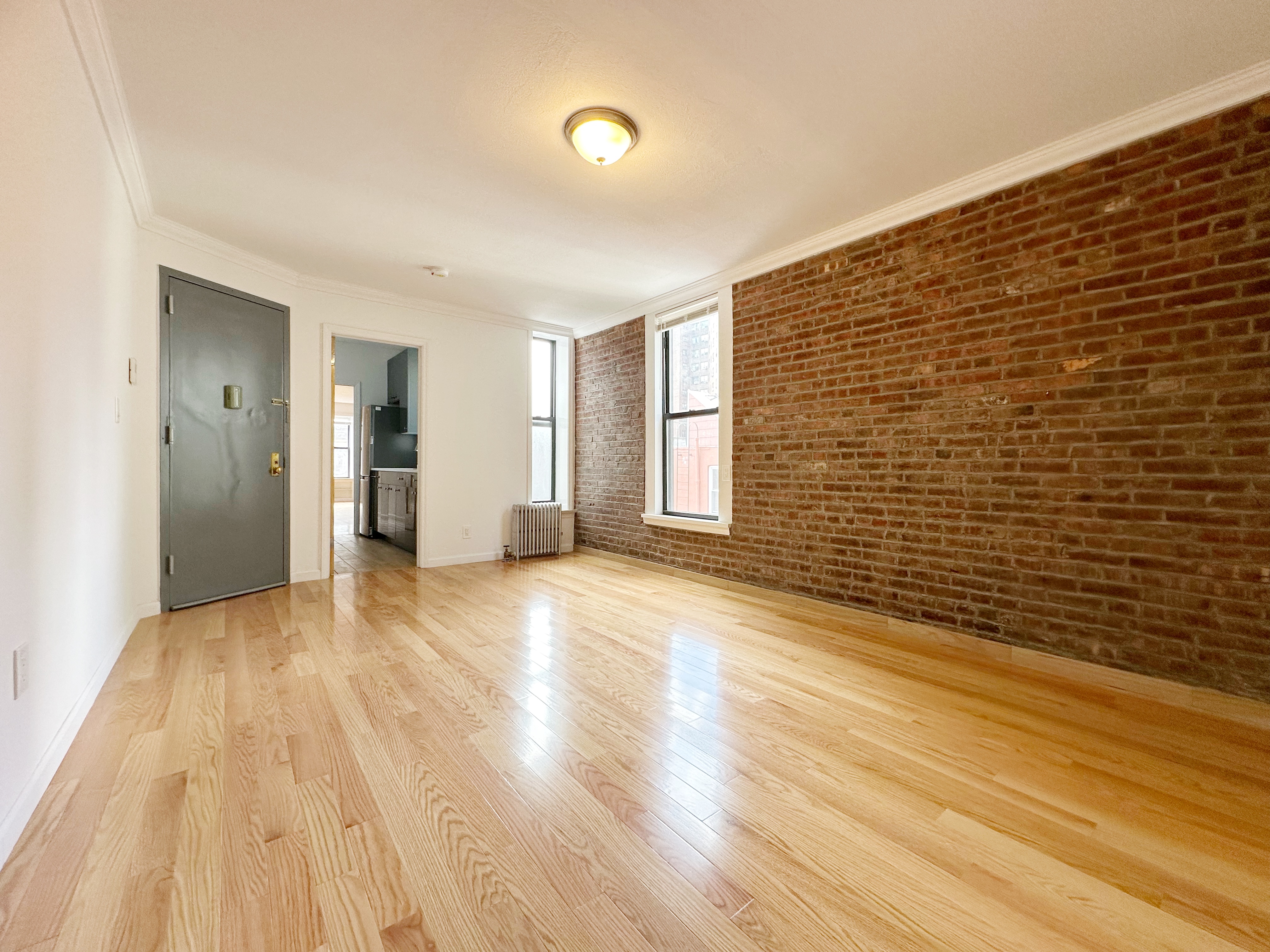 75 Madison Street, Unit 9 Manhattan, NY 10002 - Photo 1 of 6 a view of empty room with wooden floor