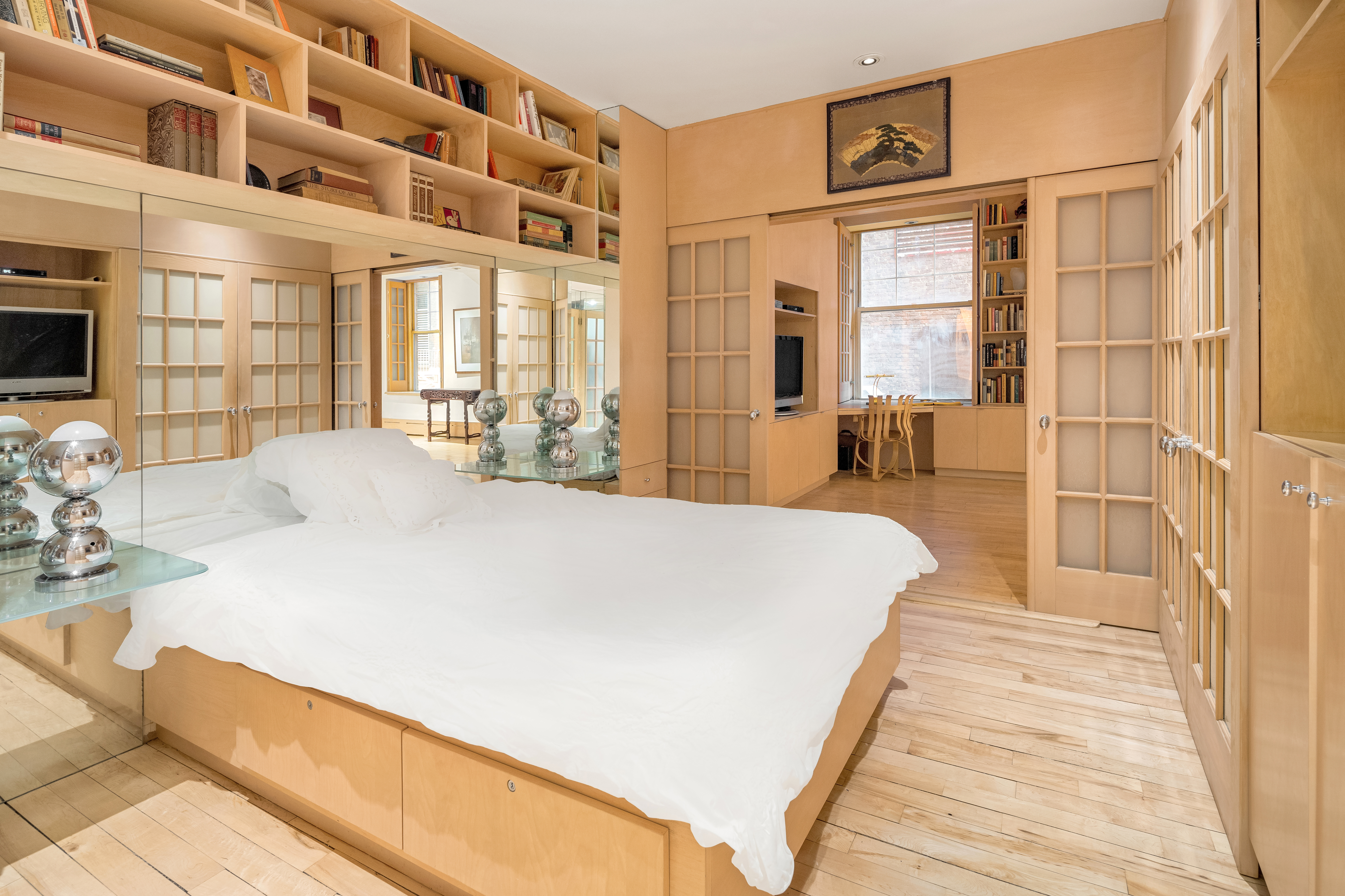 131 Mercer Street, Unit 2B Manhattan, NY 10012 - Photo 8 of 18 a large bed sitting in a bedroom next to a large window