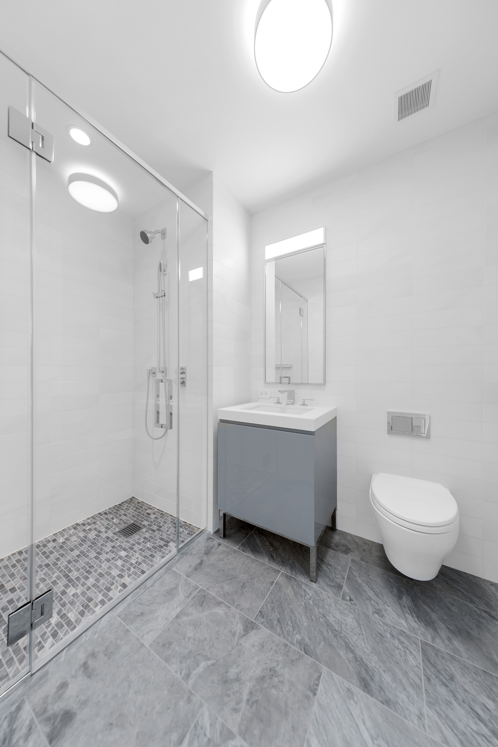 50 West 66th Street, Unit 17A Manhattan, NY 10023 - Photo 13 of 49 a bathroom with a double vanity sink toilet mirror and bathtub