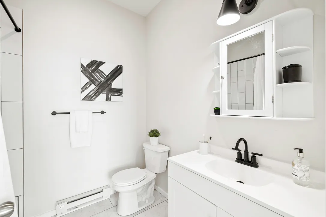 a living room with furniture a chandelier and a flat screen tv
