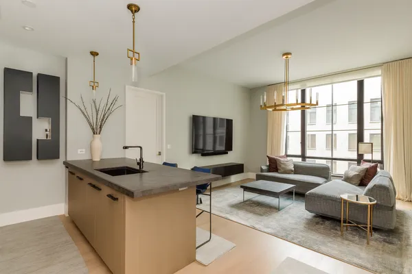 a kitchen with stainless steel appliances granite countertop a sink and a refrigerator