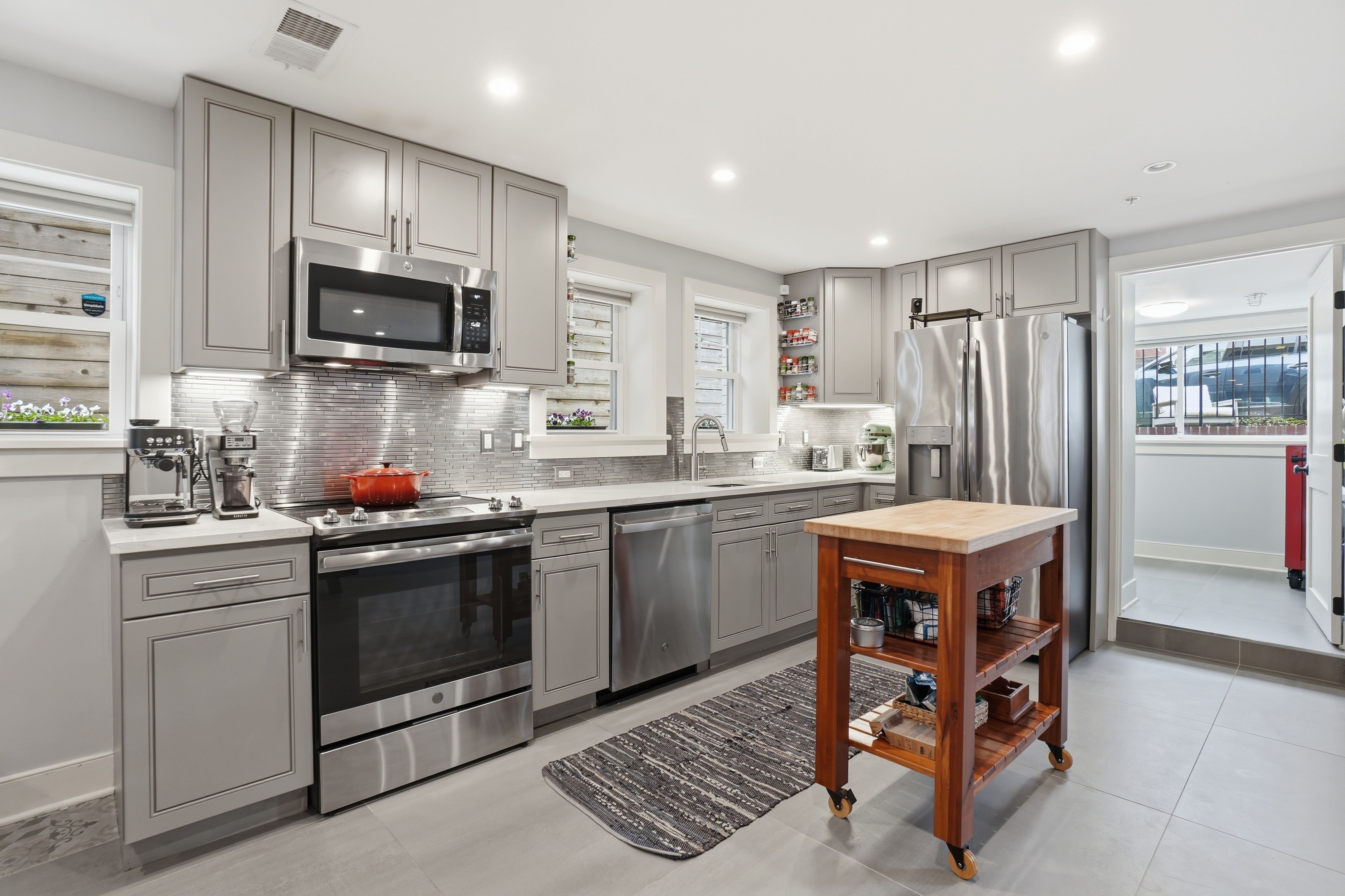 1244 Raum Street Northeast, Unit 5 Washington, DC 20002 - Photo 5 of 21 a kitchen with stainless steel appliances a stove a sink a microwave a refrigerator and cabinets