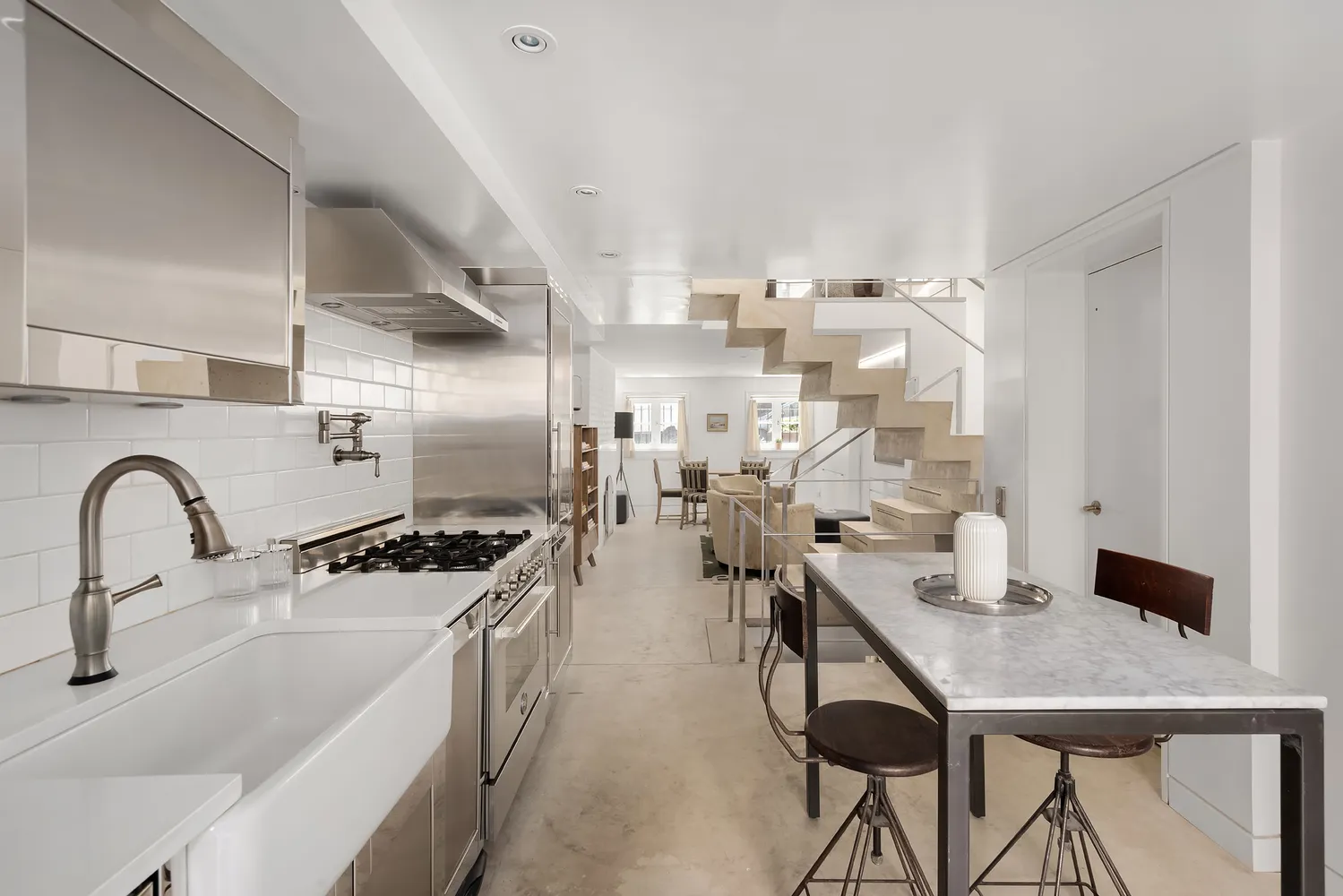 a kitchen with lots of counter top space and stainless steel appliances