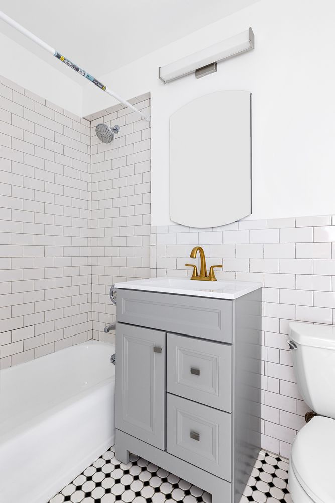 7 East 14th Street, Unit 17RS Manhattan, NY 10003 - Photo 6 of 9 a bathroom with a sink toilet and shower