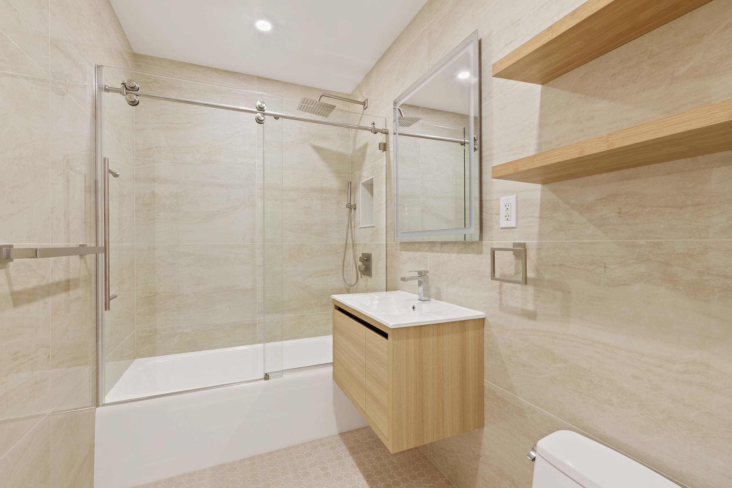 450 West 17th Street, Unit 1123 Manhattan, NY 10011 - Photo 3 of 6 a bathroom with a sink a toilet and shower