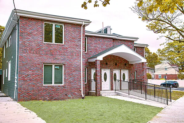 a front view of a house with a yard