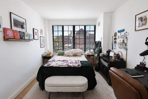 a very nice looking bedroom with a large bed a couch and dresser