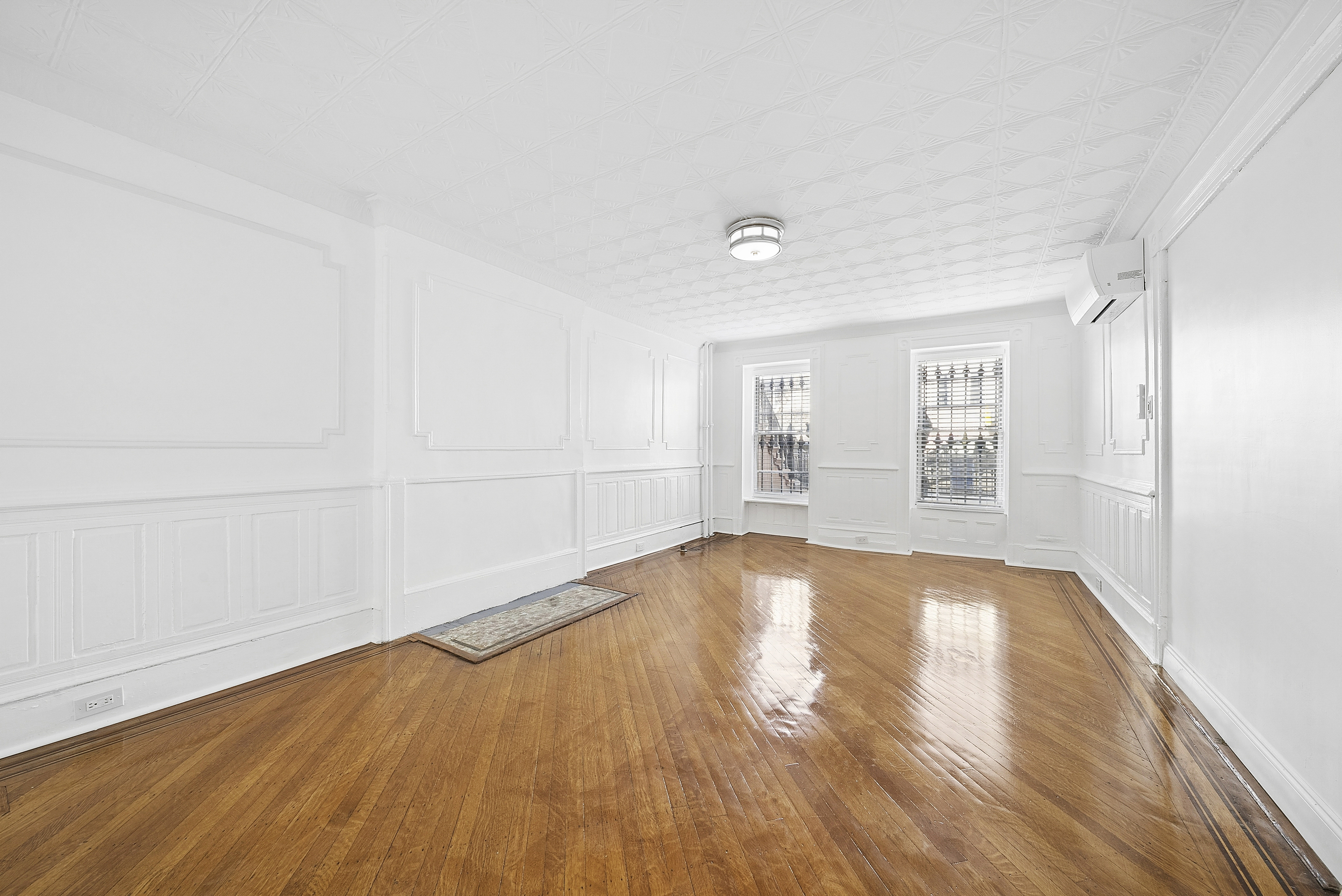490 A Monroe Street, Unit apt.1 Brooklyn, NY 11221 - Photo 7 of 12 an empty room with wooden floor and windows