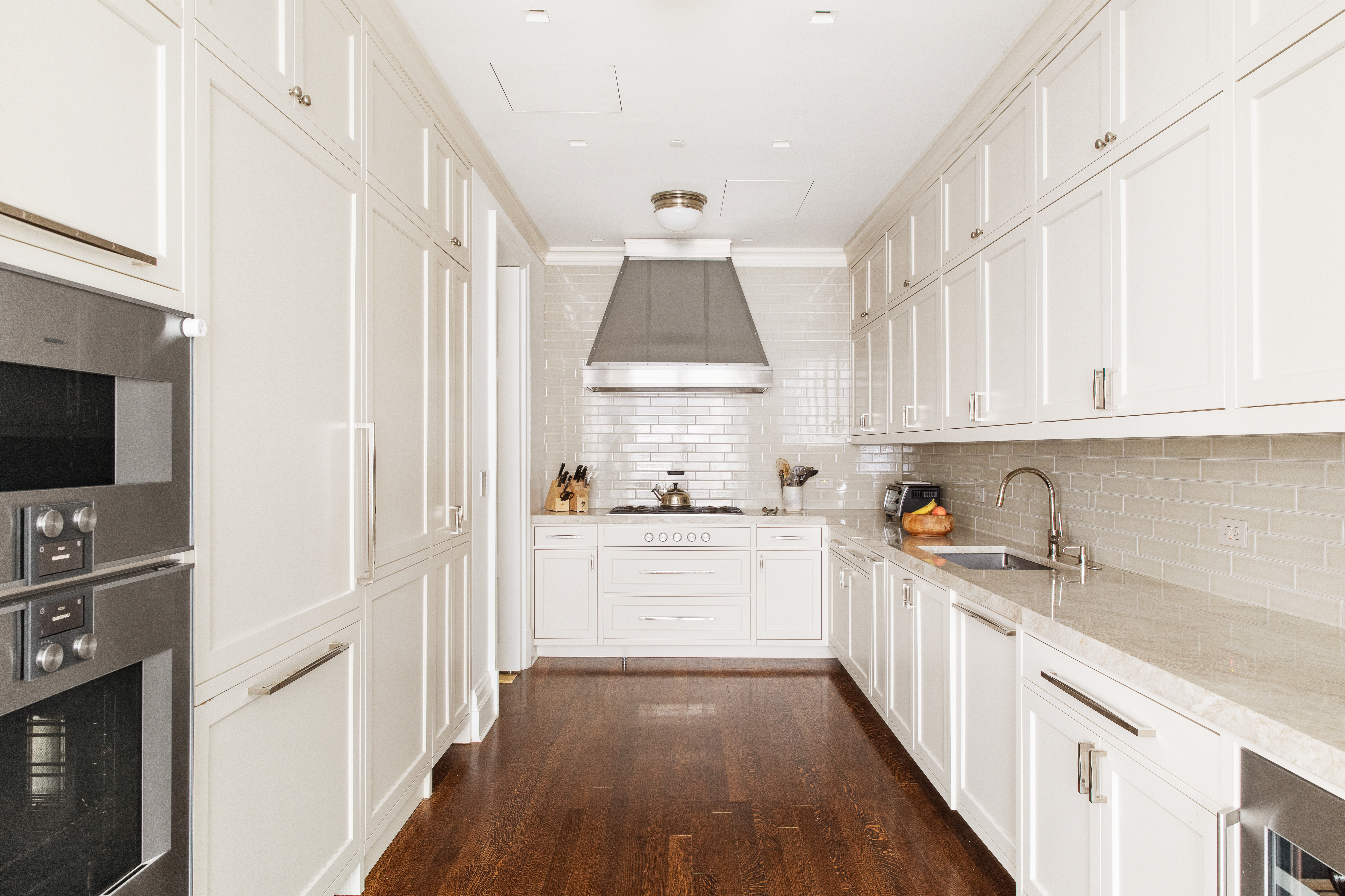20 East End Avenue, Unit 4C Manhattan, NY 10028 - Photo 3 of 23 a kitchen with granite countertop white cabinets and white appliances