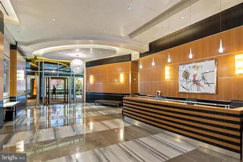 a lobby with furniture and wall paintings