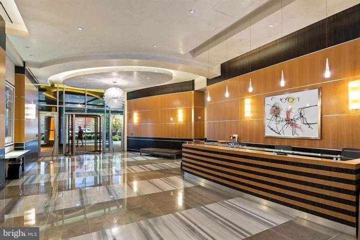 a lobby with furniture and wall paintings
