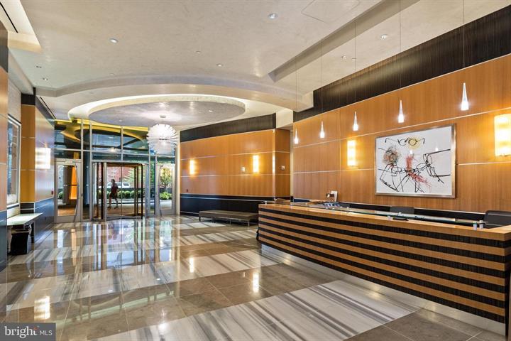 1881 North Nash Street, Unit 1009 Arlington, VA 22209 - Photo 32 of 36 a lobby with furniture and wall paintings