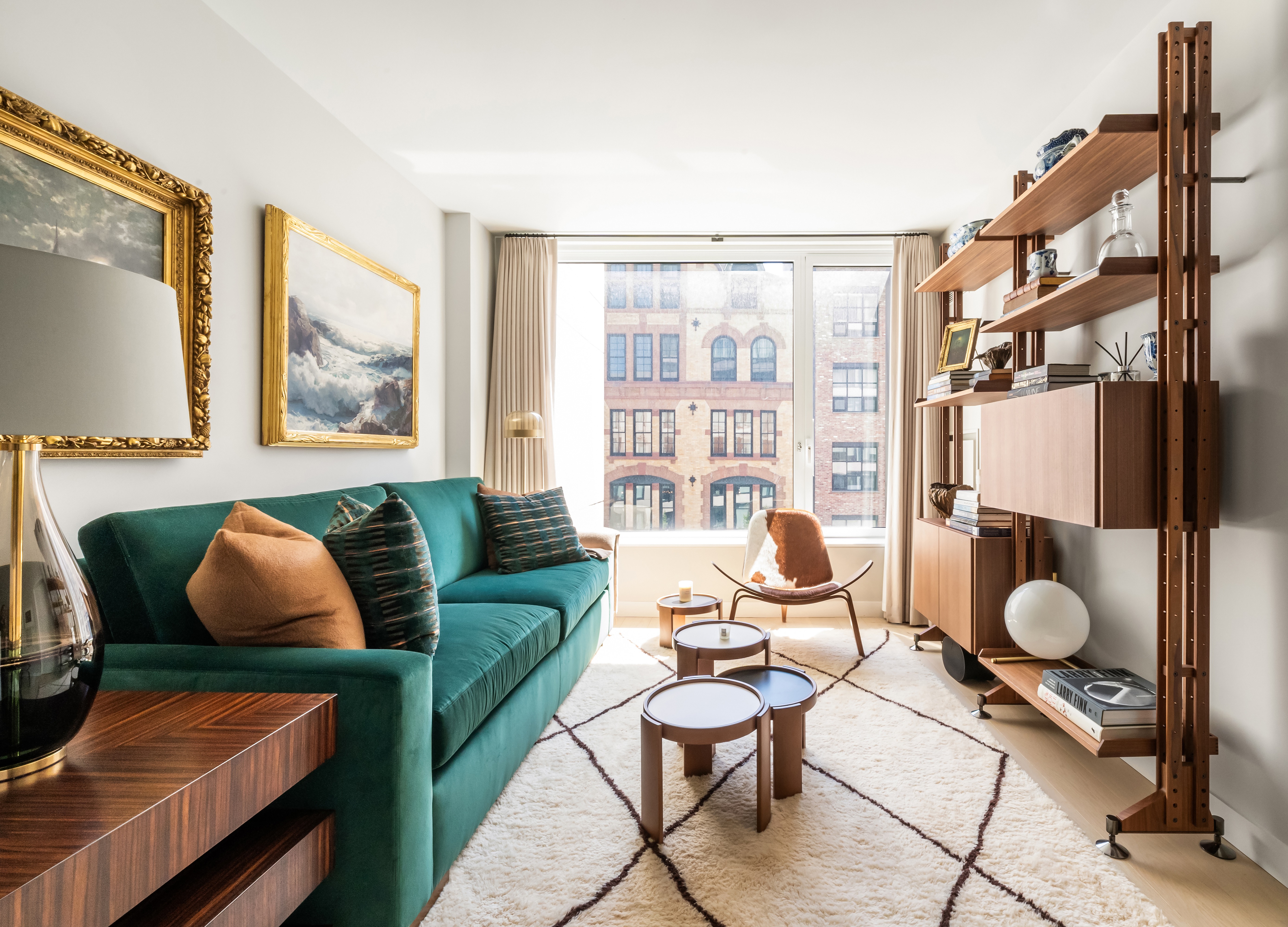 a living room with furniture and a floor to ceiling window