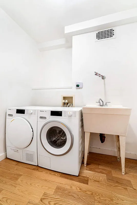 333 East 66th Street, Unit 2FE Manhattan, NY 10065 - Photo 14 of 19 a utility room with sink dryer and washer