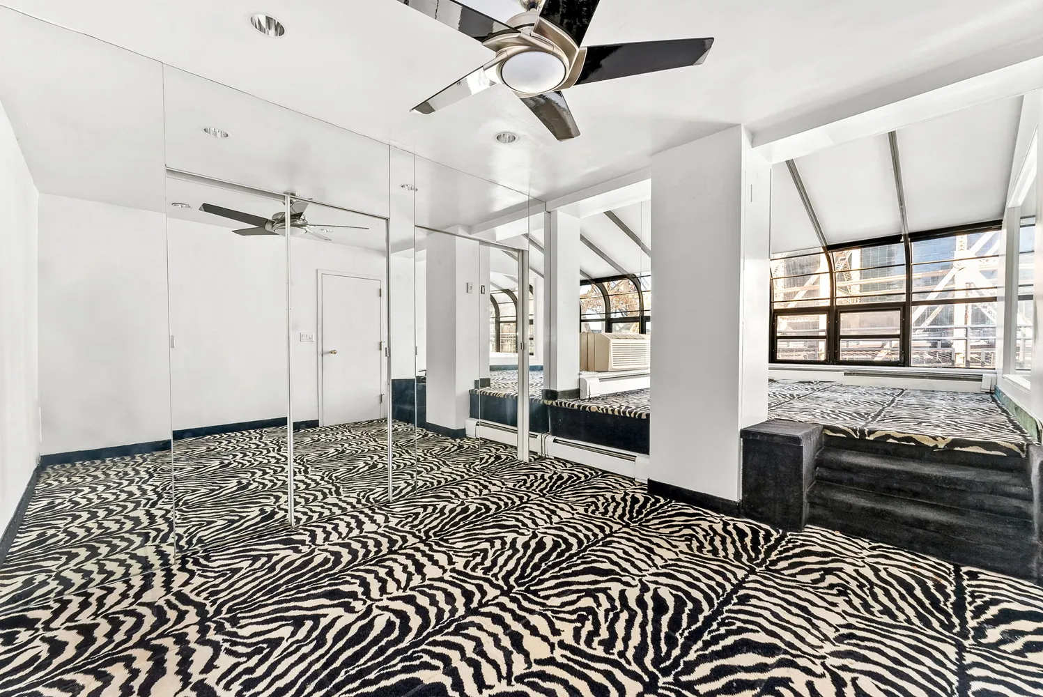 a living room with a black white checkered floor