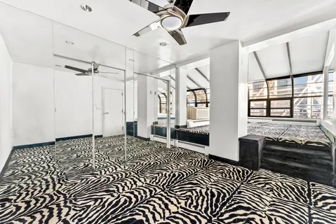 a living room with a black white checkered floor