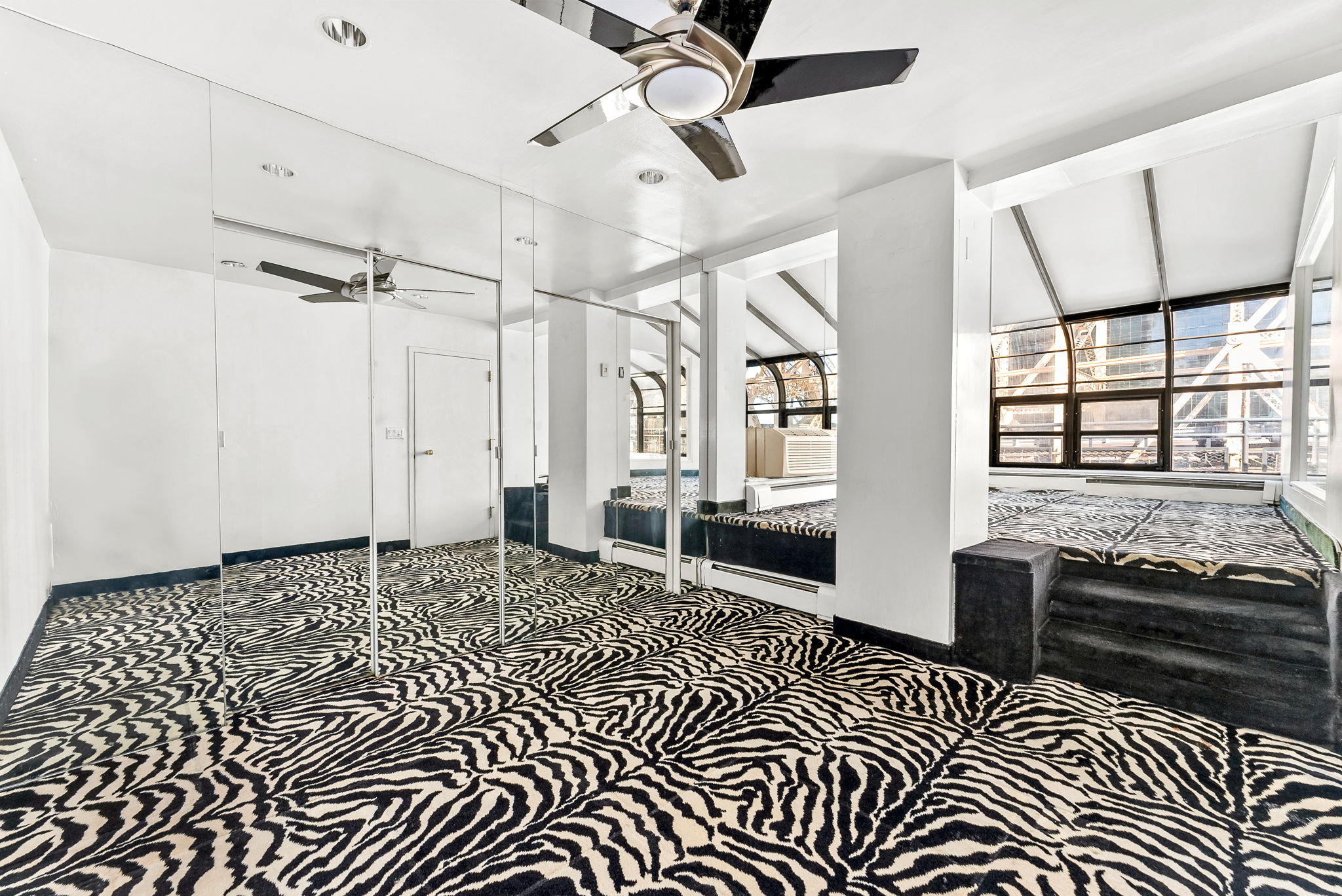 40 Sutton Place, Unit 10M Manhattan, NY 10022 - Photo 8 of 10 a living room with a black white checkered floor