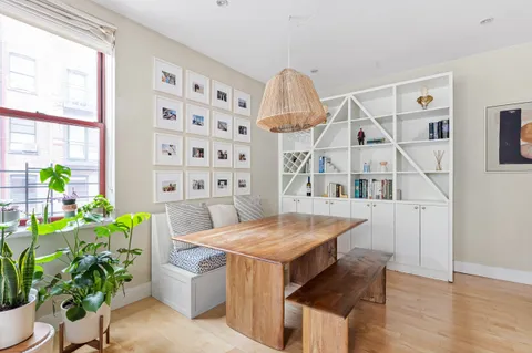 a dining room with furniture and wooden floor