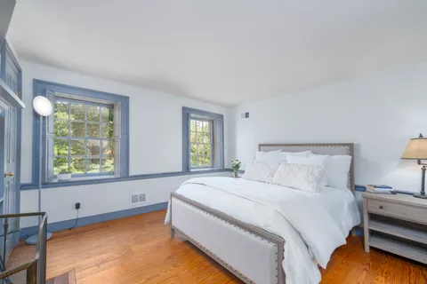 a bedroom with a bed and a table