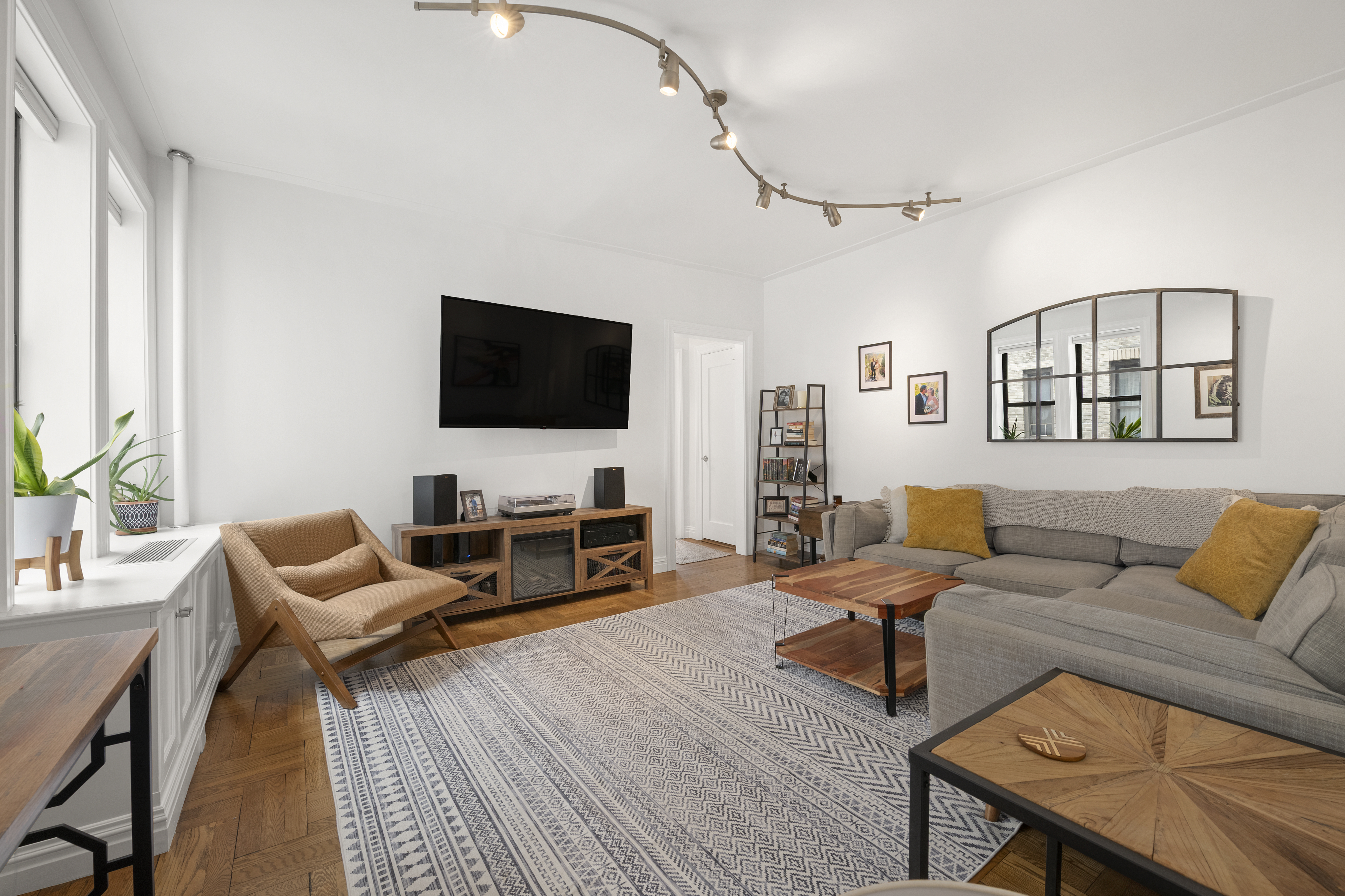 222 East 82nd Street, Unit 5E Manhattan, NY 10028 - Photo 2 of 10 a living room with furniture and a flat screen tv