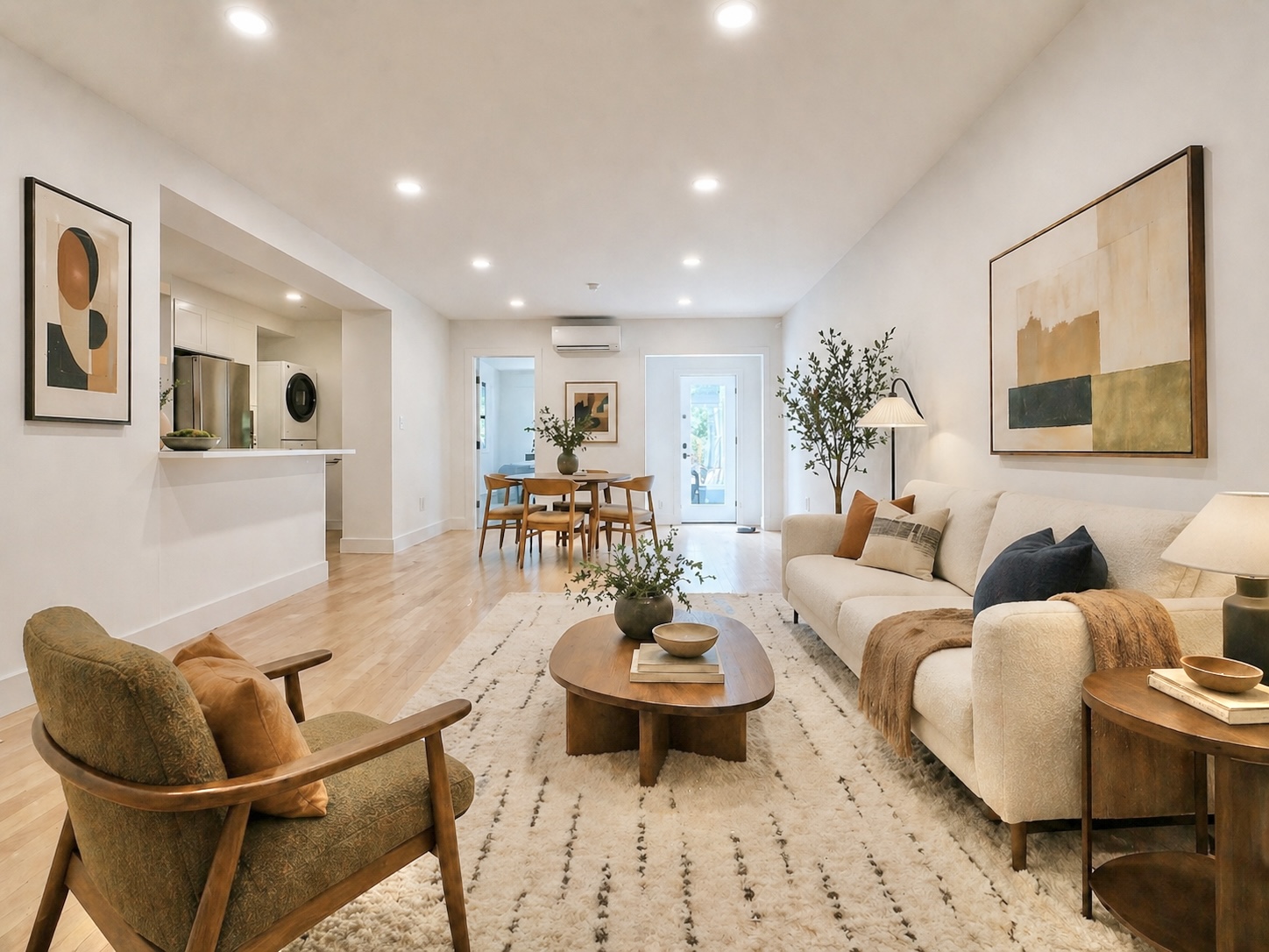 a living room with furniture and painting on the wall