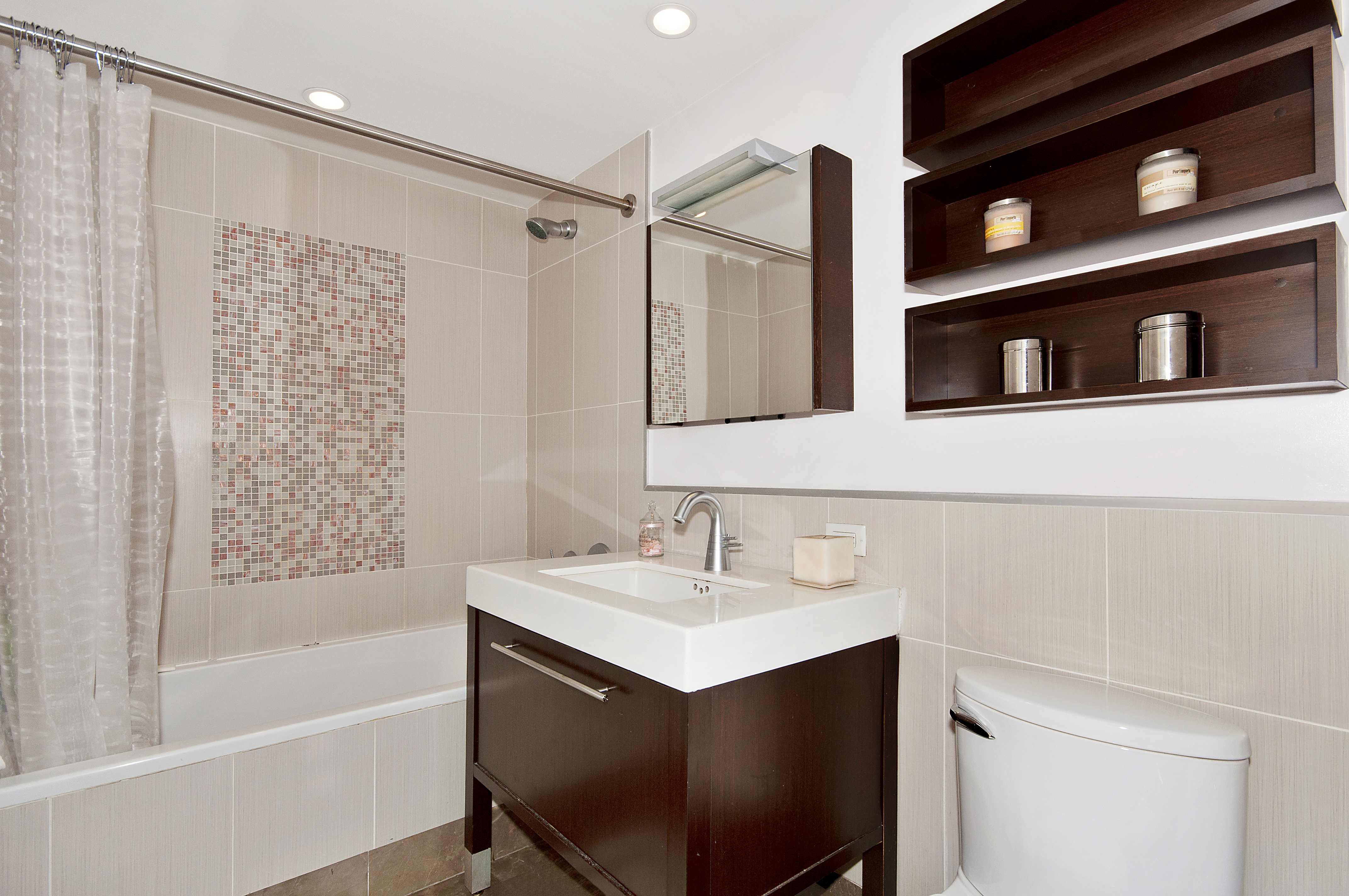 225 East 34th Street, Unit 17C Manhattan, NY 10016 - Photo 7 of 19 a bathroom with a sink and a shower