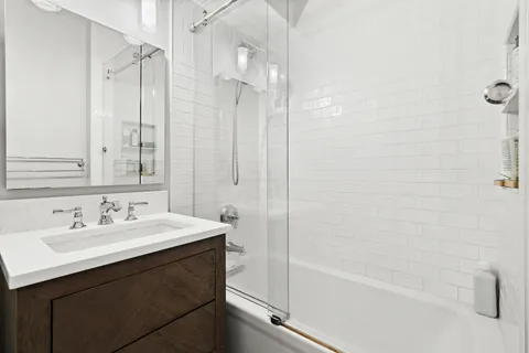 a bathroom with a sink a mirror and a bathtub