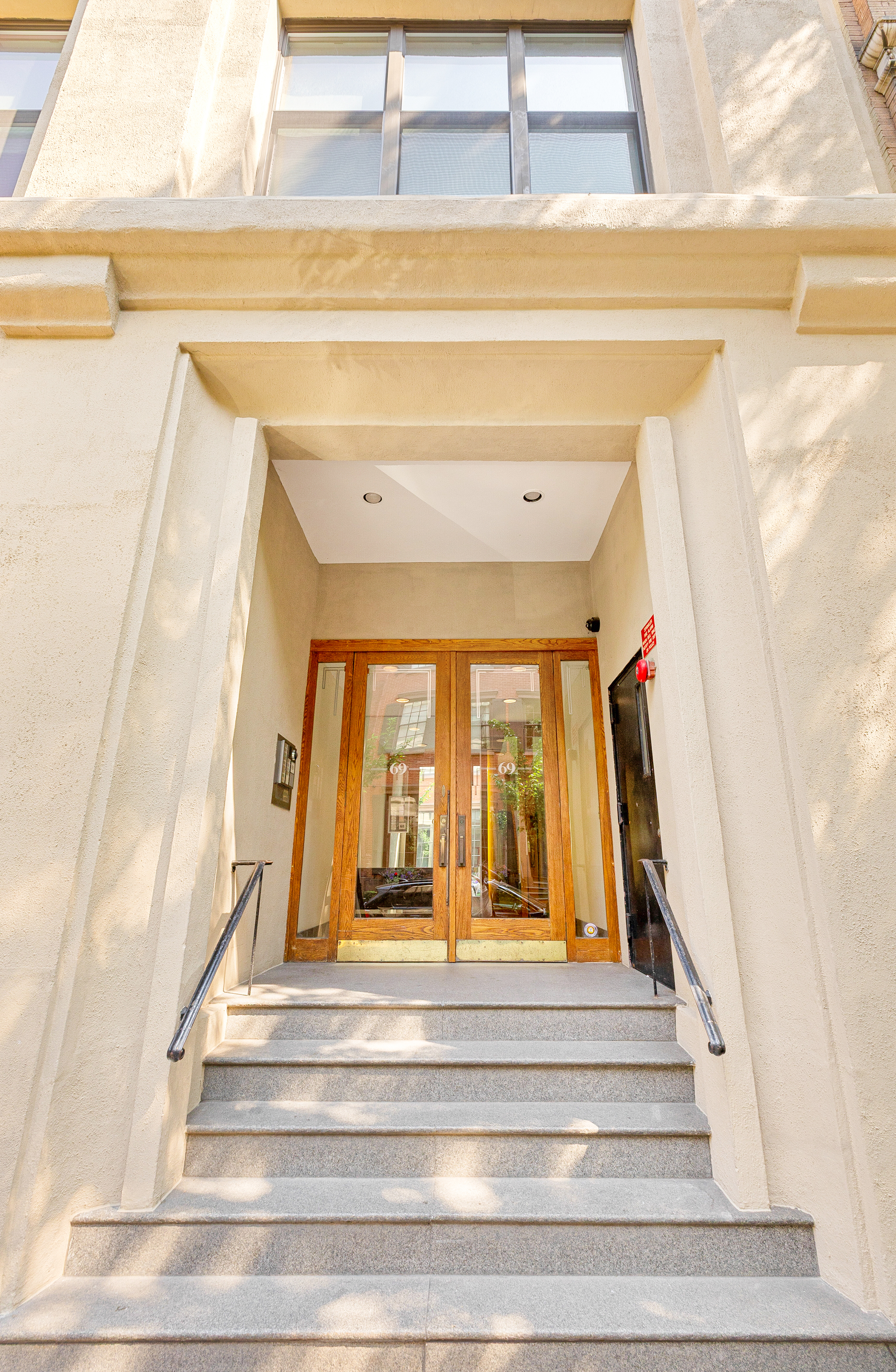 69 Bank Street, Unit 203 Manhattan, NY 10014 - Photo 21 of 23 a view of staircase with white walls and windows