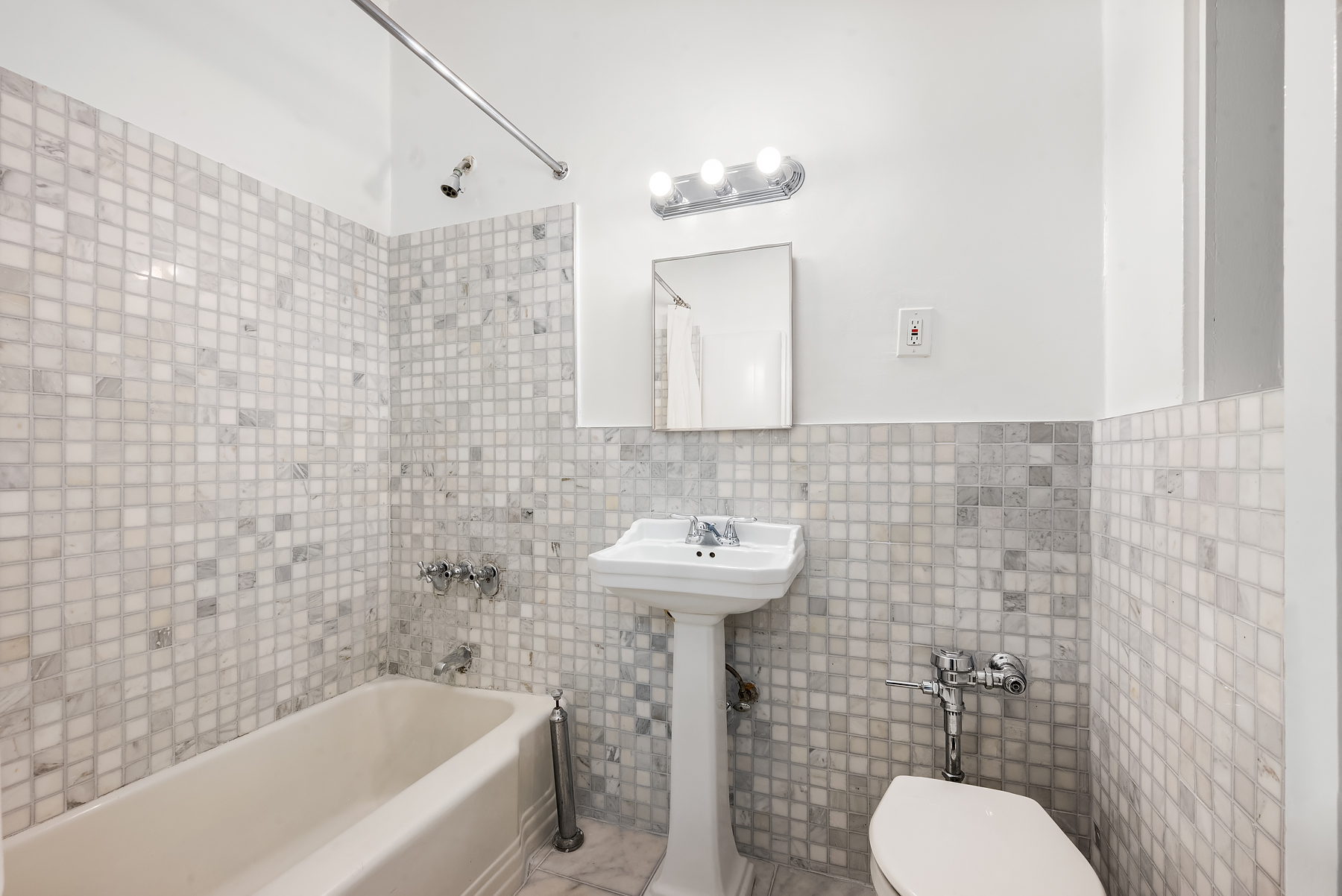 124 East 91st Street, Unit 3D Manhattan, NY 10128 - Photo 7 of 11 a bathroom with a sink a toilet and bathtub
