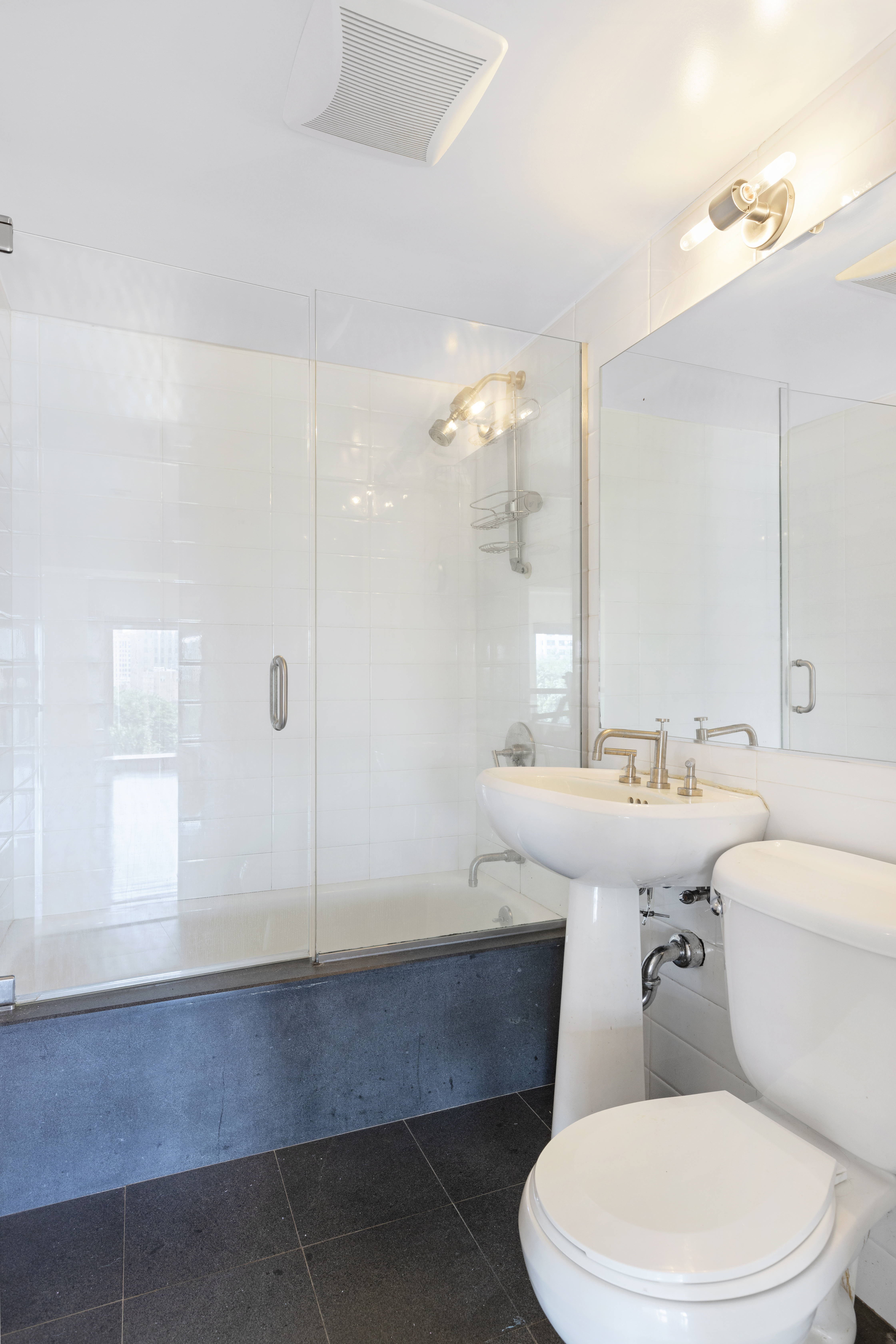 305 2nd Avenue, Unit 537 Manhattan, NY 10003 - Photo 10 of 11 a bathroom with a sink a toilet a mirror and shower
