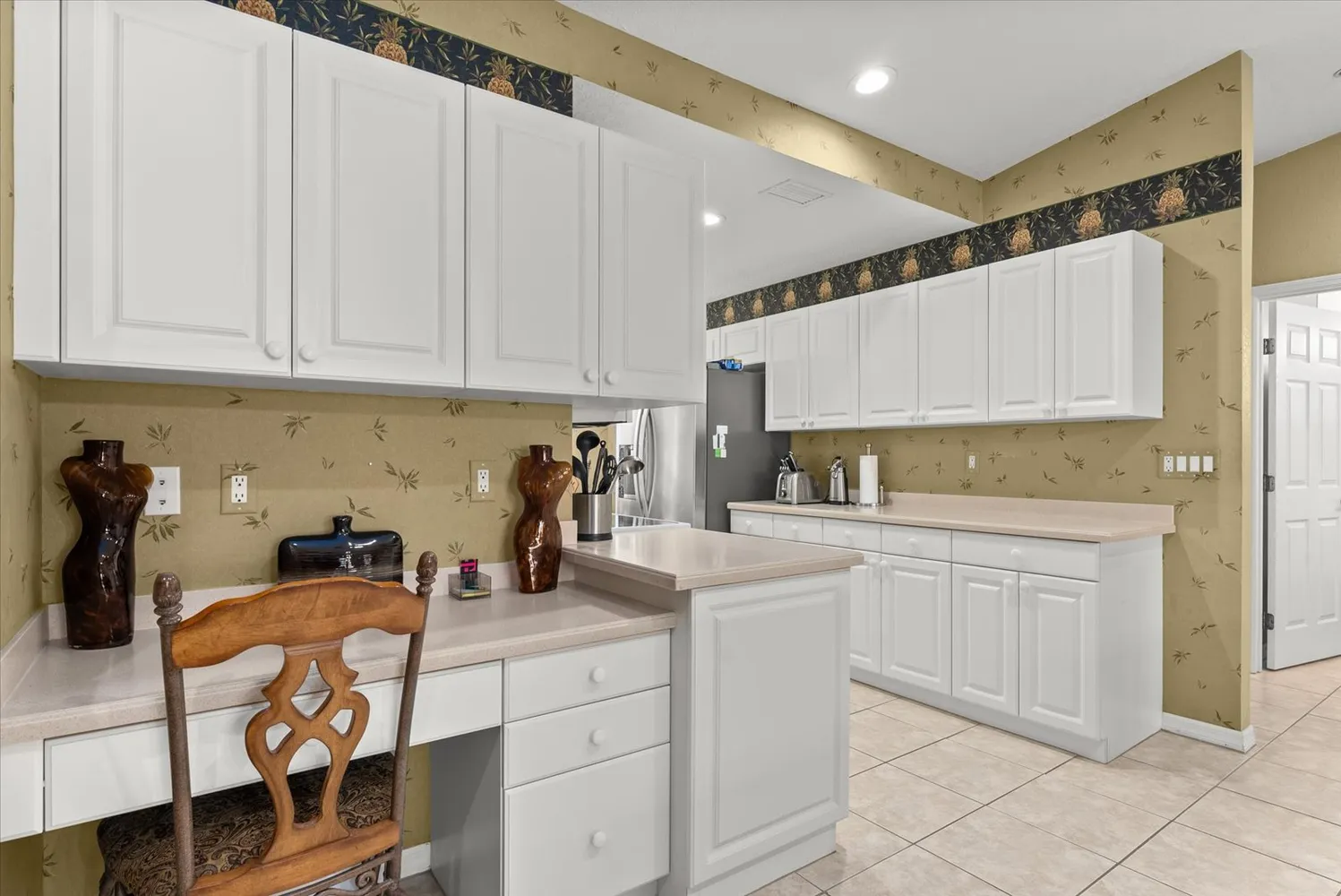 a kitchen with cabinets and appliances