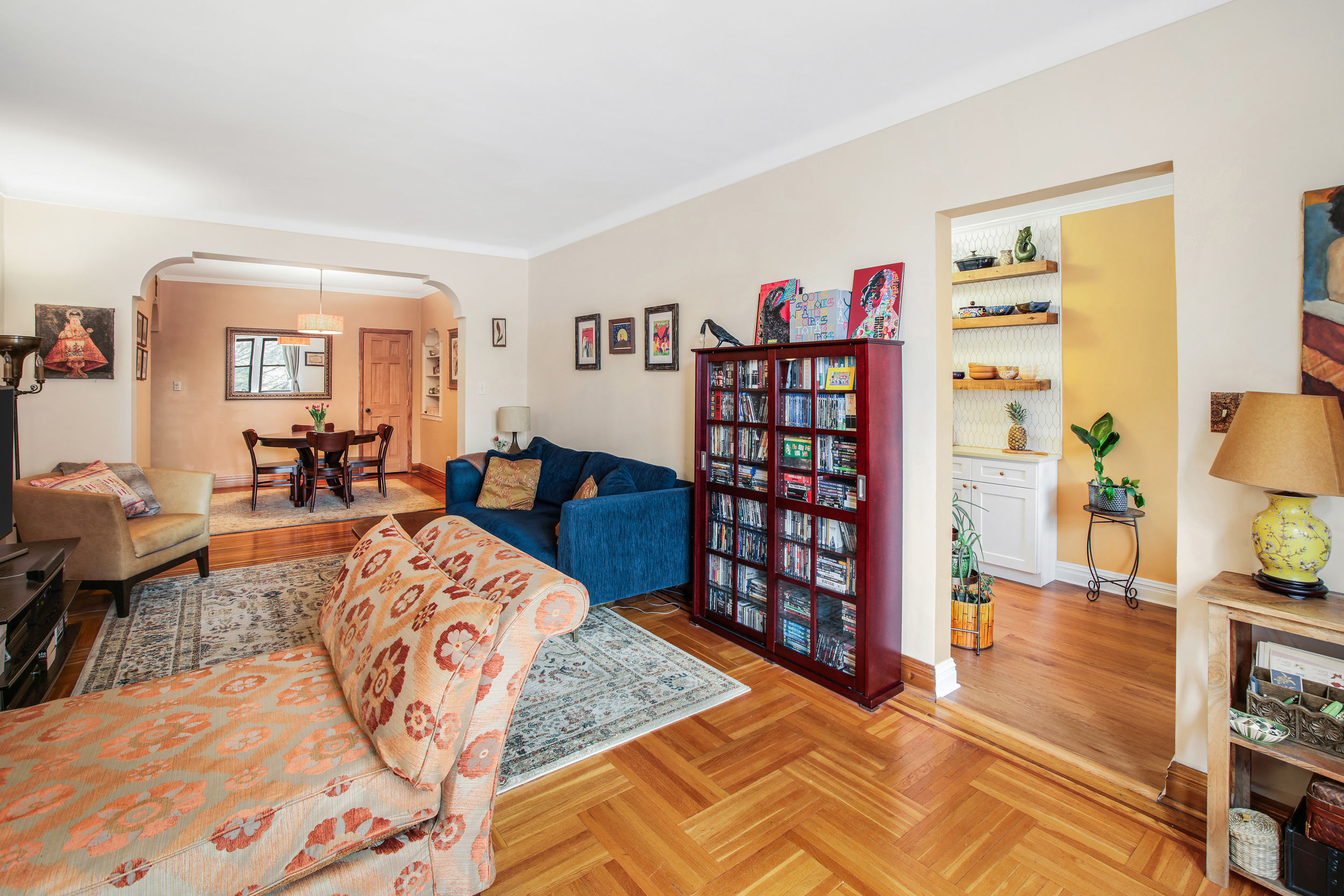 657 East 26th Street, Unit 3G Brooklyn, NY 11210 - Photo 2 of 14 a living room with furniture and a book shelf