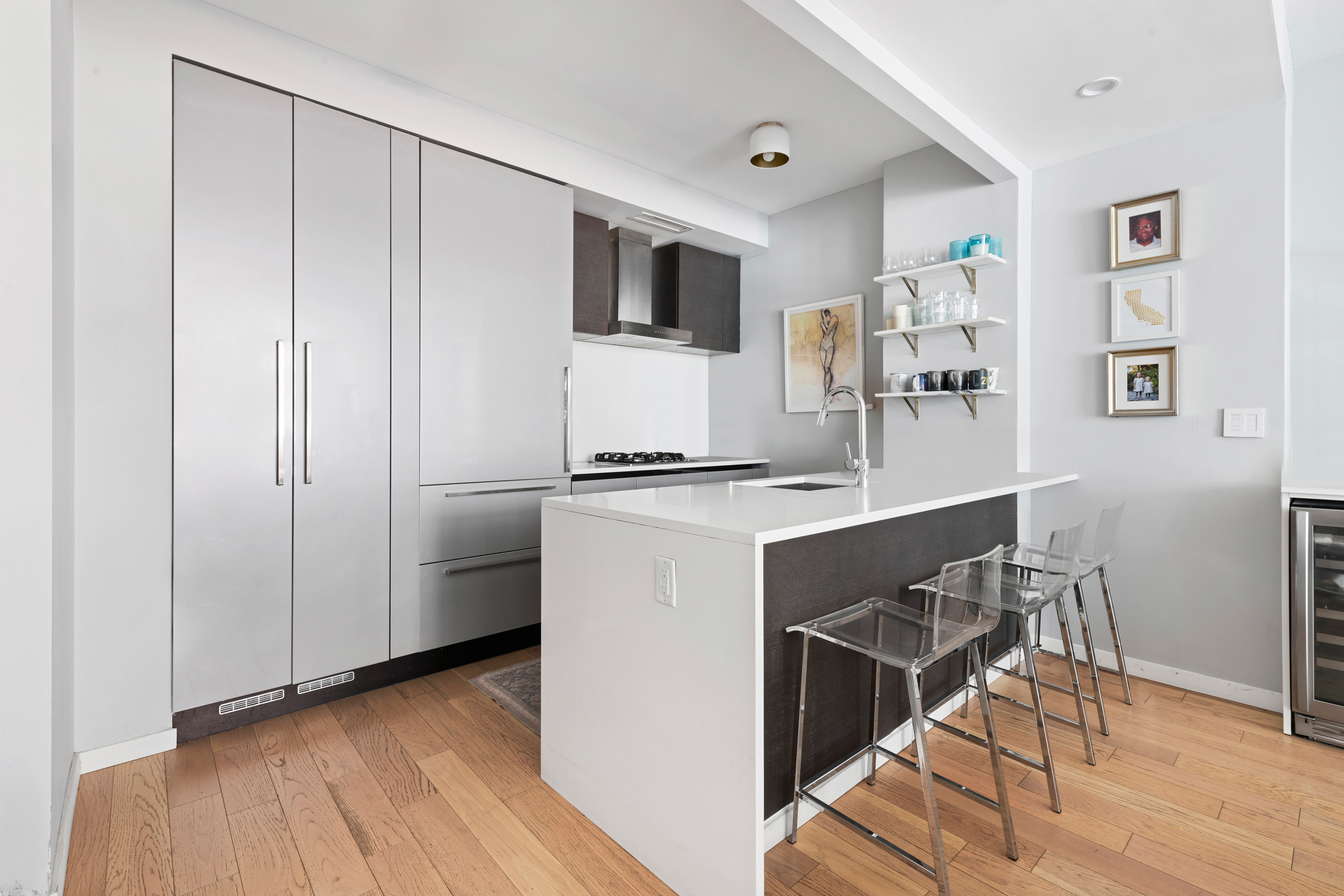 540 West 49th Street, Unit 401S Manhattan, NY 10019 - Photo 5 of 14 a kitchen with stainless steel appliances a refrigerator and a stove top oven