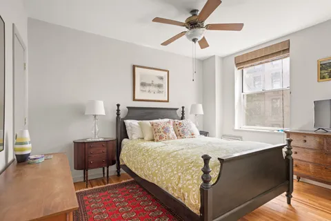 a bedroom with a bed and a table in it