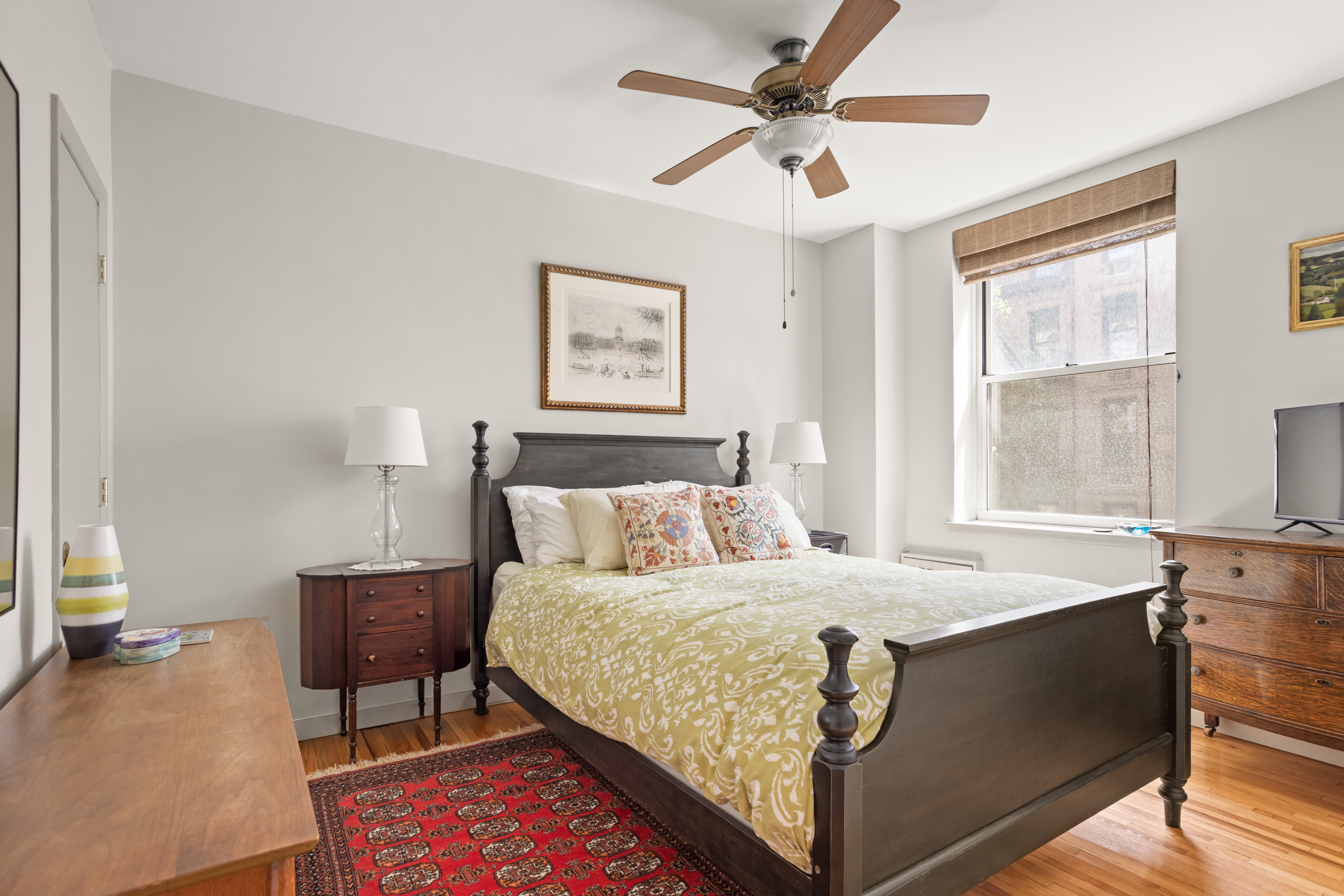 161 East 90th Street, Unit 3B Manhattan, NY 10128 - Photo 7 of 11 a bedroom with a bed and a table in it