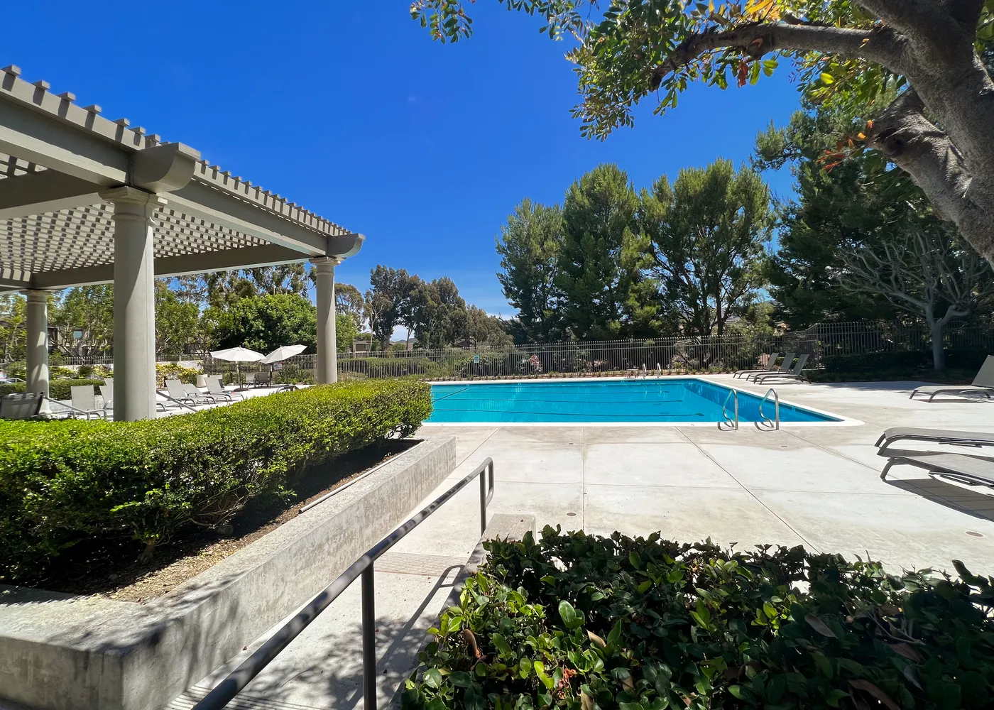 a view of yard with swimming pool and green space
