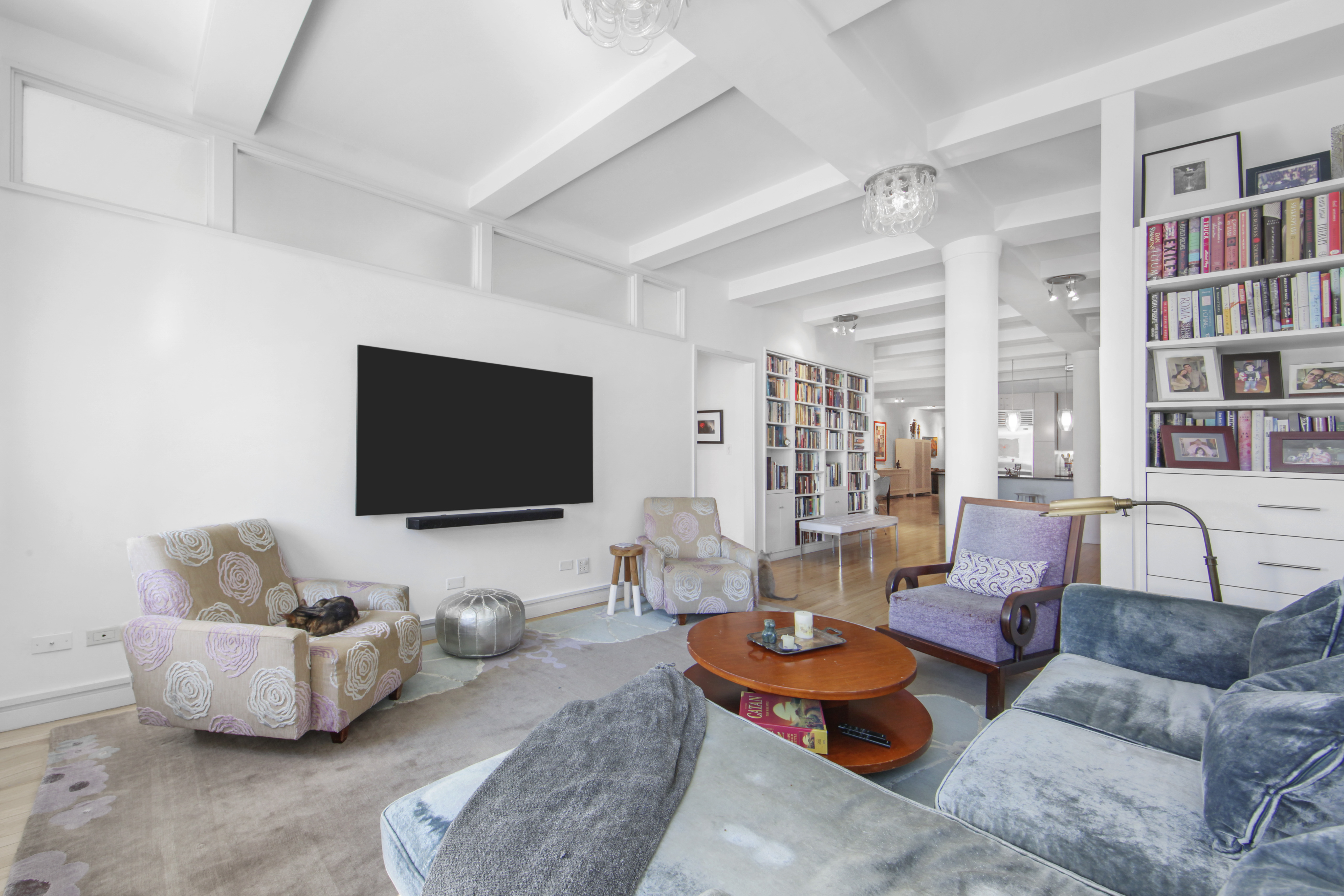 18 East 12th Street, Unit 7BC Manhattan, NY 10003 - Photo 4 of 26 a living room with furniture and a flat screen tv