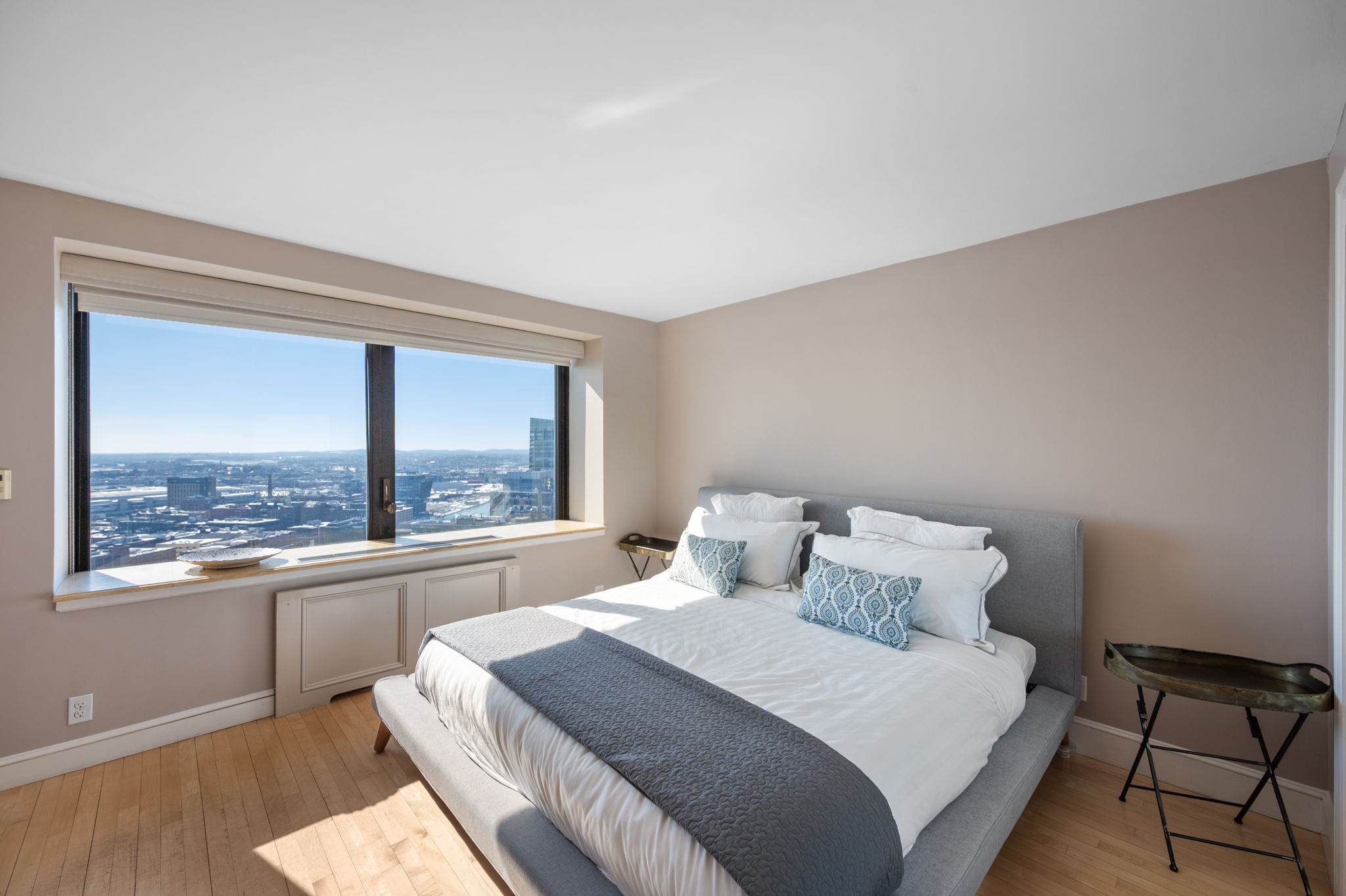 65 East India Row, Unit 38 F/G Boston, MA 02110 - Photo 13 of 32 a bedroom with a large bed and a large window