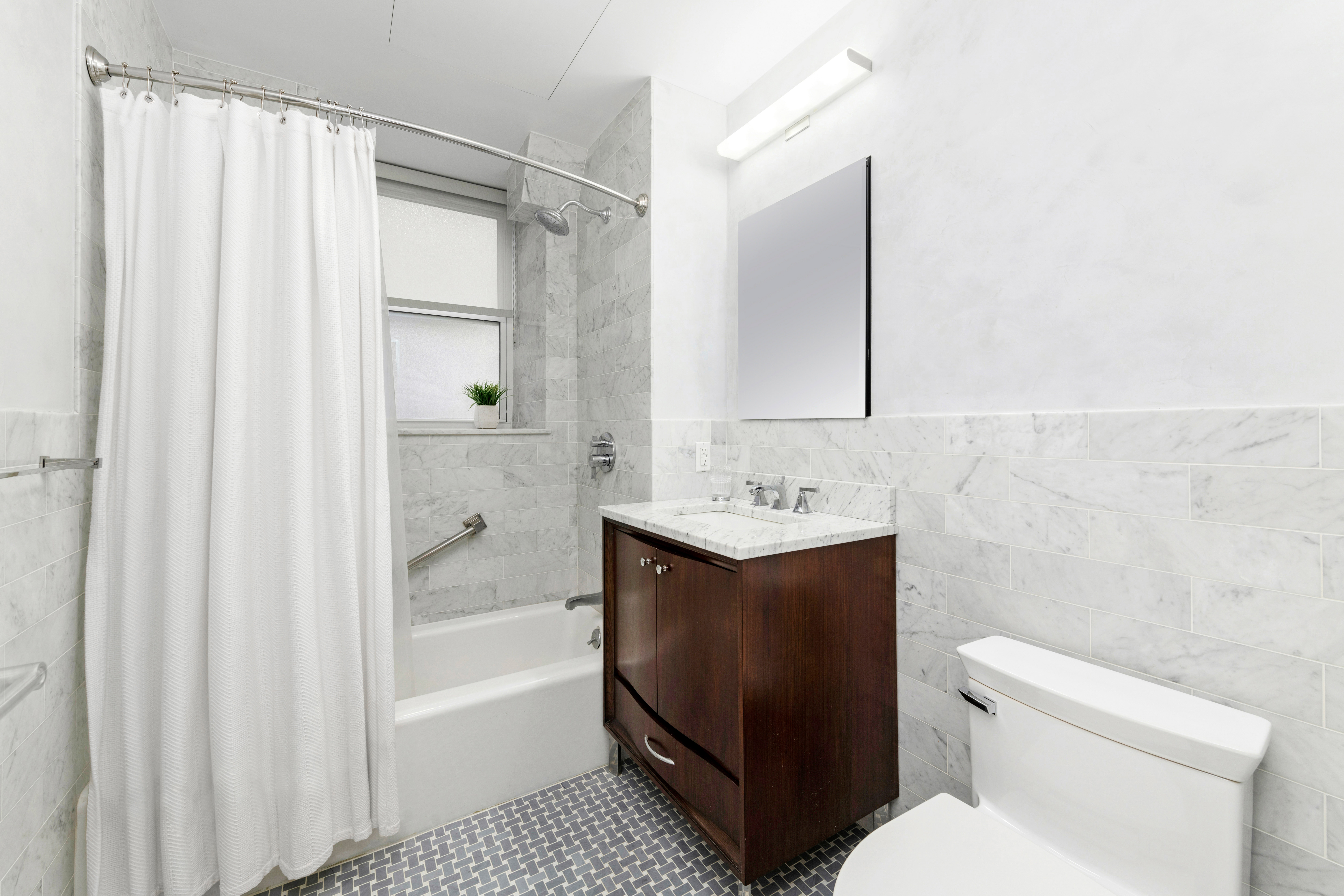 1 West 67th Street, Unit 206 Manhattan, NY 10023 - Photo 6 of 13 a bathroom with a sink toilet and shower
