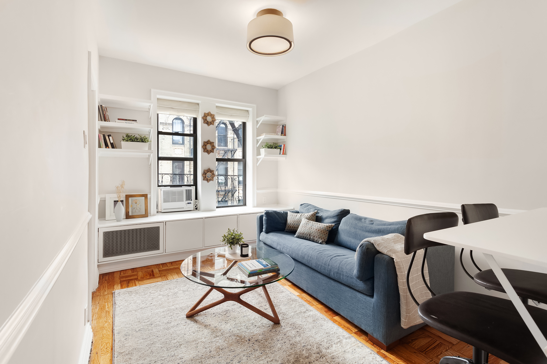 181 Thompson Street, Unit 19 Manhattan, NY 10012 - Photo 1 of 7 a living room with furniture a rug and a window