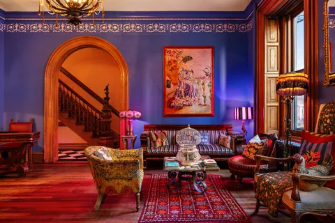 a living room with furniture a rug and entryway