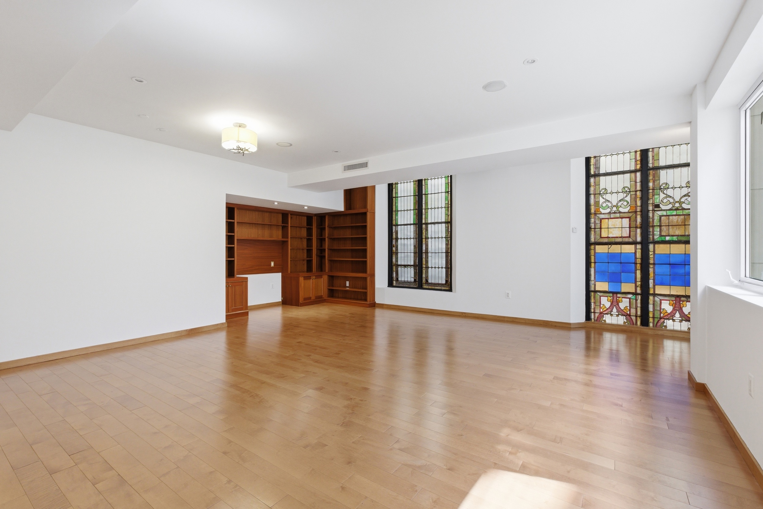 135 West 4th Street, Unit 3W Manhattan, NY 10012 - Photo 2 of 24 wooden floor in an empty room with a window