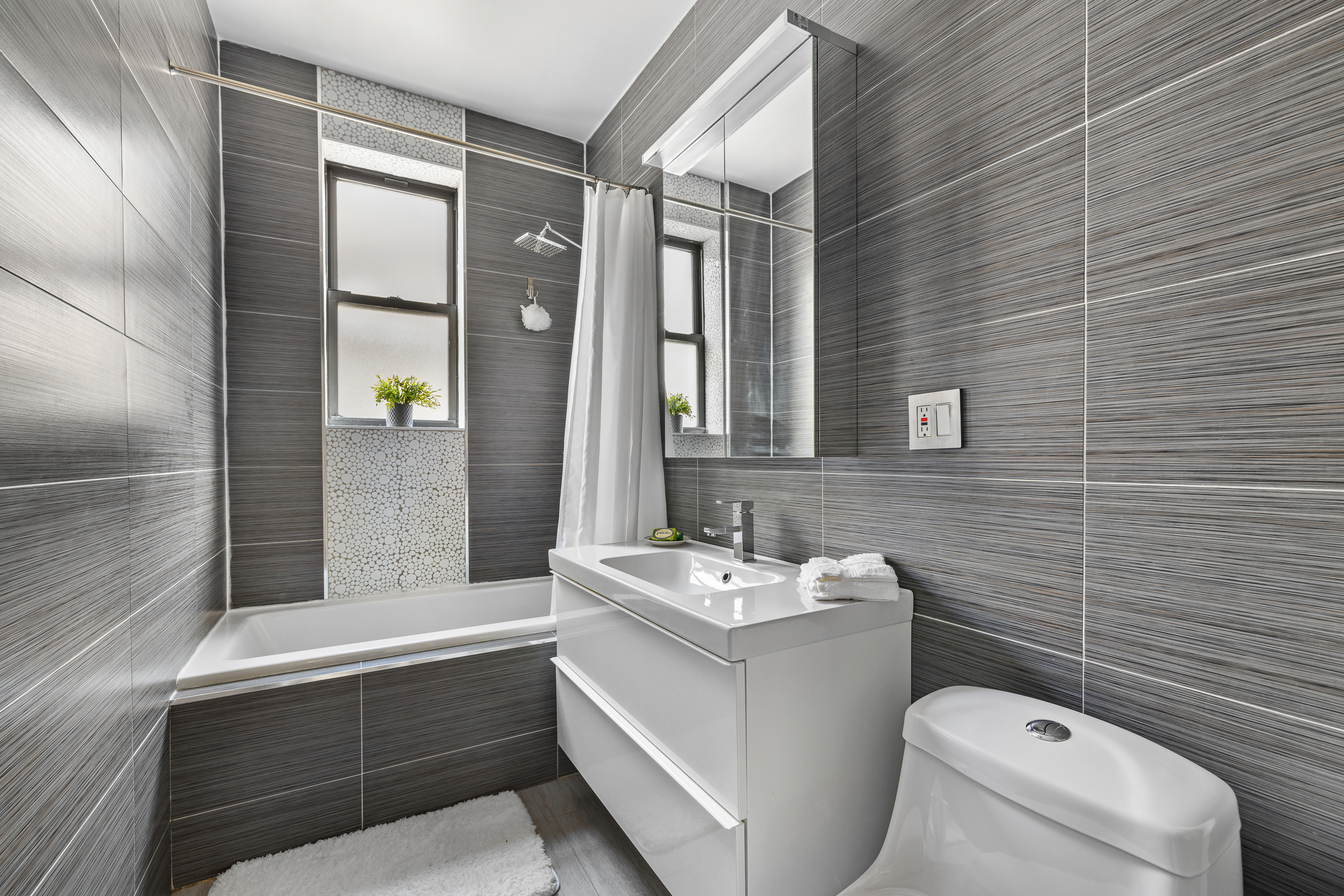 839 East 19th Street, Unit 4D Brooklyn, NY 11230 - Photo 6 of 10 a bathroom with a sink a toilet and shower