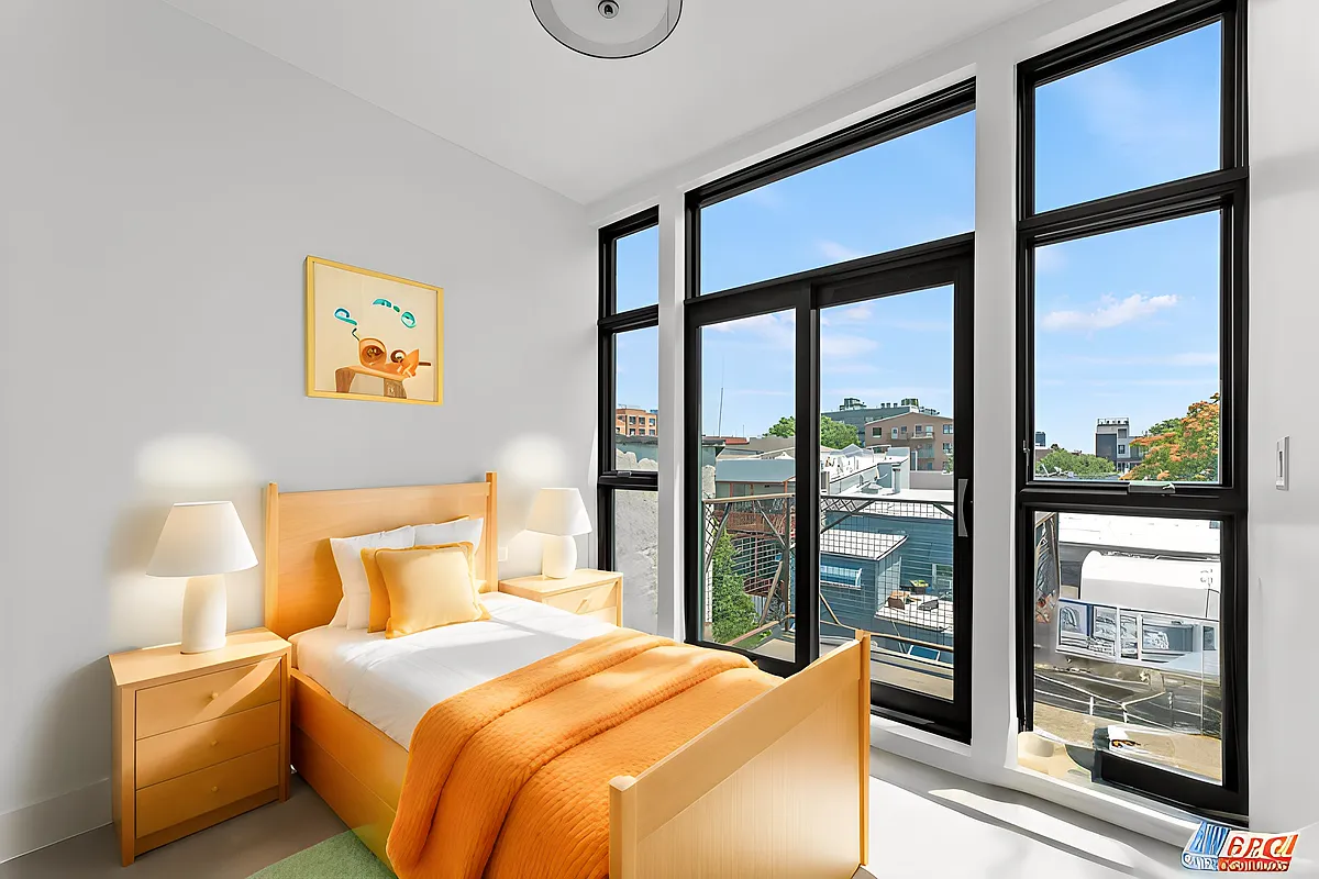 30 Belvidere Street, Unit PH4 Brooklyn, NY 11206 - Photo 5 of 8 a bedroom with a bed and a large window