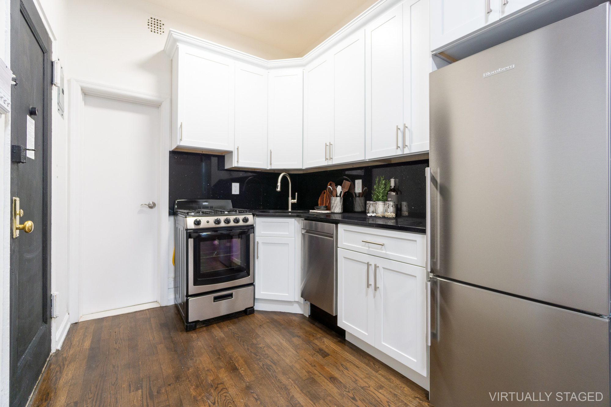339 East 6th Street, Unit B Manhattan, NY 10003 - Photo 13 of 22 a kitchen with stainless steel appliances a refrigerator sink and stove