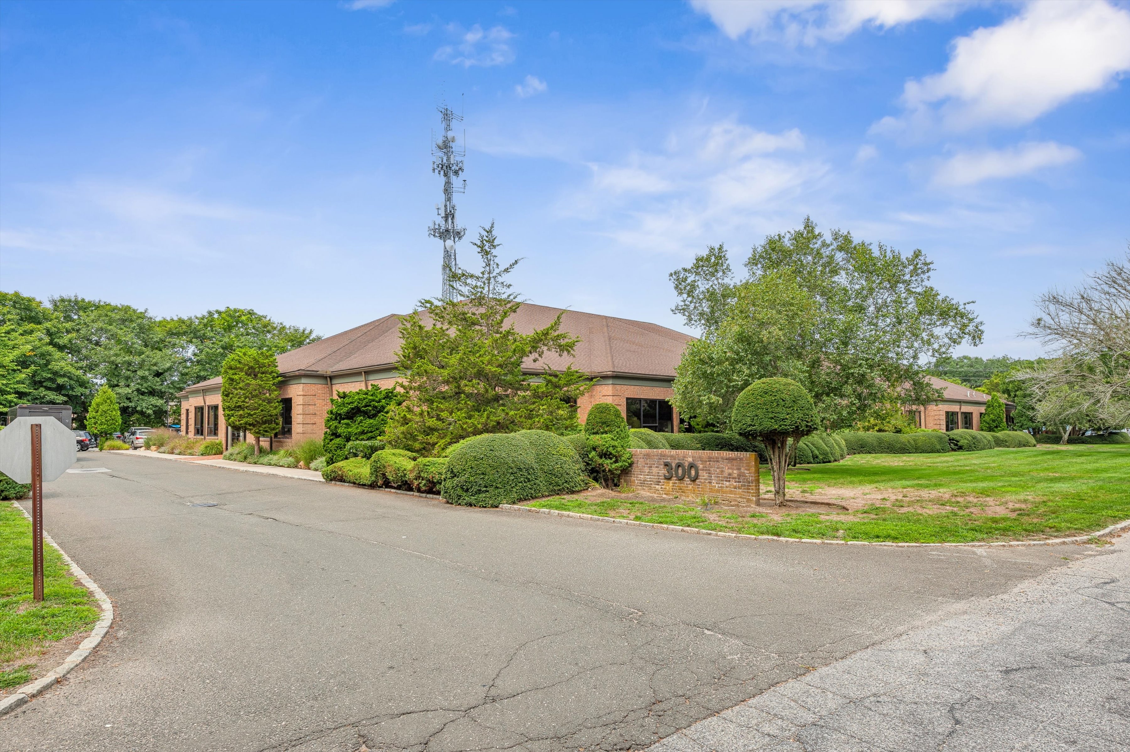 300 Pantigo Road East Hampton, NY 11937 - Photo 2 of 18 a front view of a house with a yard and garage