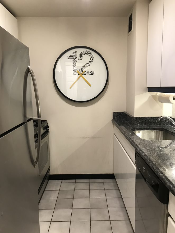 50 Lexington Avenue, Unit 9F Manhattan, NY 10010 - Photo 2 of 7 an entryway with a granite countertop a sink a stove and a mirror